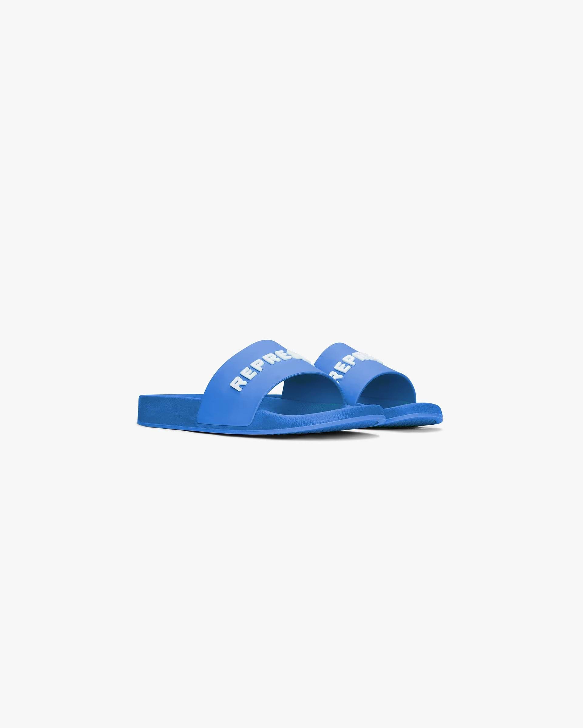 Back product image of mens blue slides on a plain white background | Represent Pool Slide in Cobalt | Slides with raised logo and soft footbed | SC24 Footwear | Represent Clo