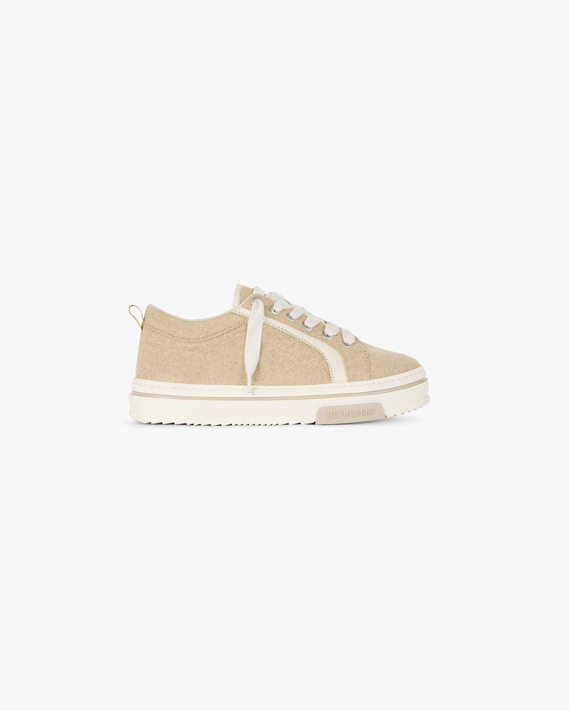 Front product image of mens beige footwear on a plain white background | HTN Low Rustic in Latte | Heavy weight premium sneakers | SC24 Footwear | Represent Clo