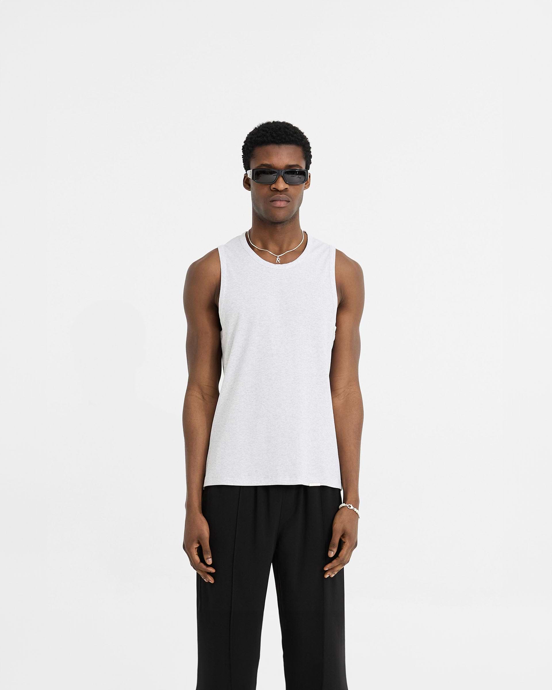 Man wearing a grey rib vest on a plain white background | Initial Rib Vest in Ice Grey Marl | Lightweight soft rib vest with regular fit | Initial T-Shirts | Represent Clo