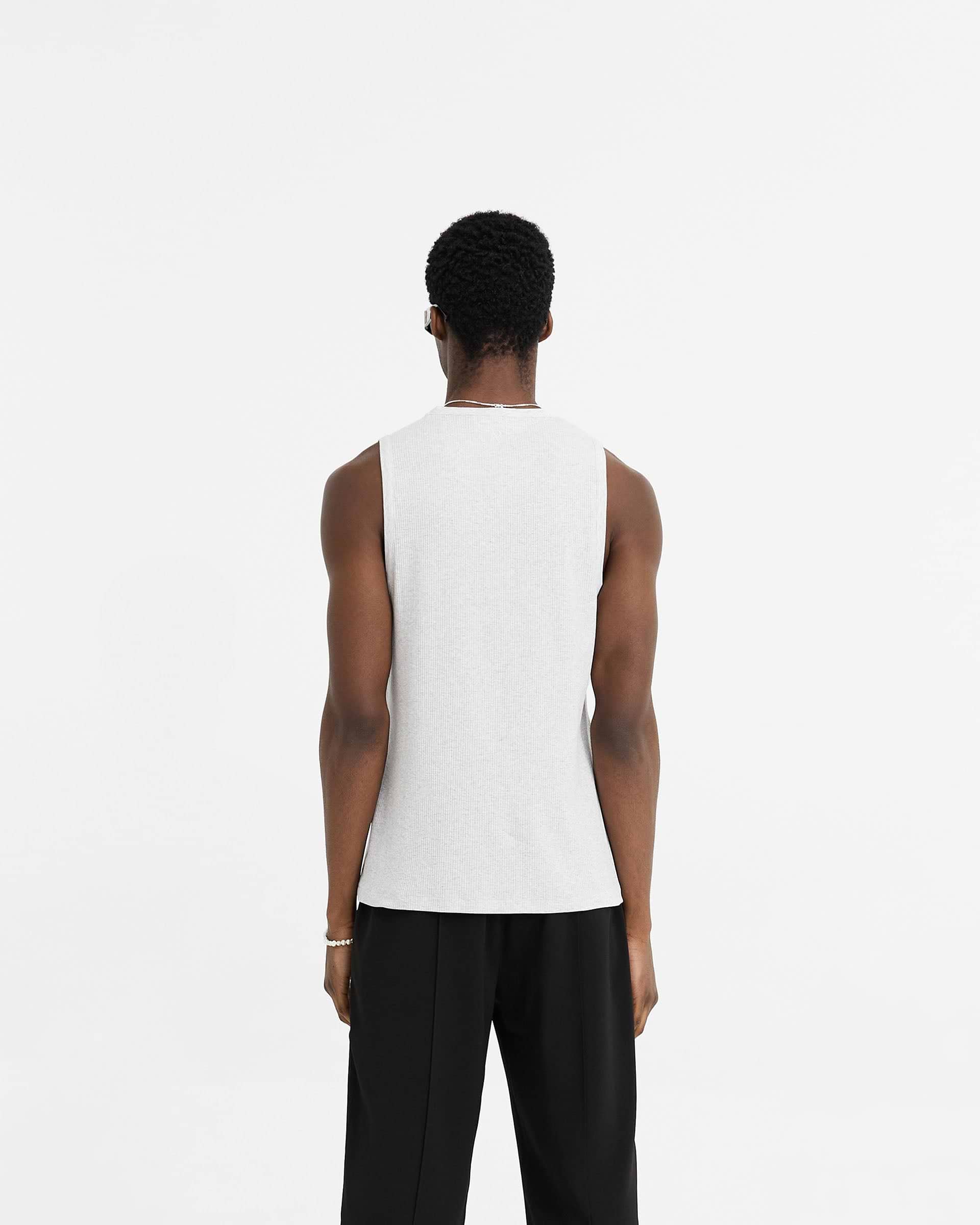 Man wearing a grey rib vest on a plain white background | Initial Rib Vest in Ice Grey Marl | Regular fit lightweight rib vest | Initial T-Shirts | Represent Clo