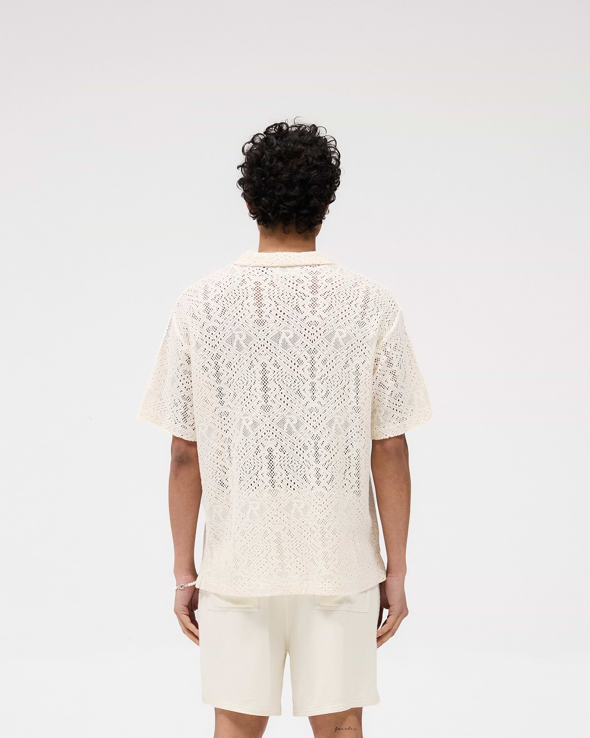 Model wearing an off white crochet shirt on a plain white background | All Over Crochet Shirt in Off White | Open-knit crochet with