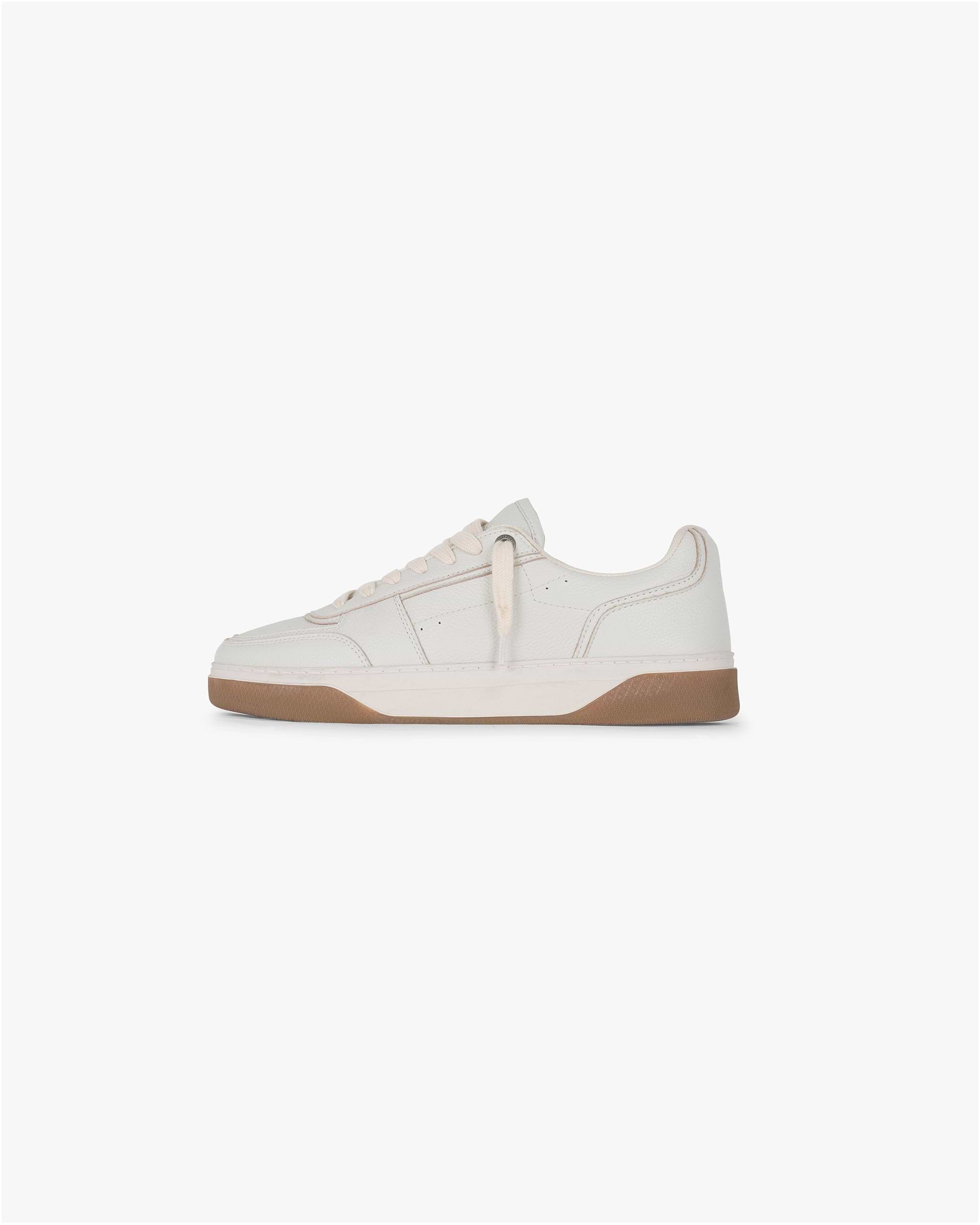 Front product image of a mens white leather sneaker on a plain white background | Initial Sneaker in Vintage White Gum | Leather sneakers with perforated toe and embossed branding | SS25 Footwear | Represent Clo