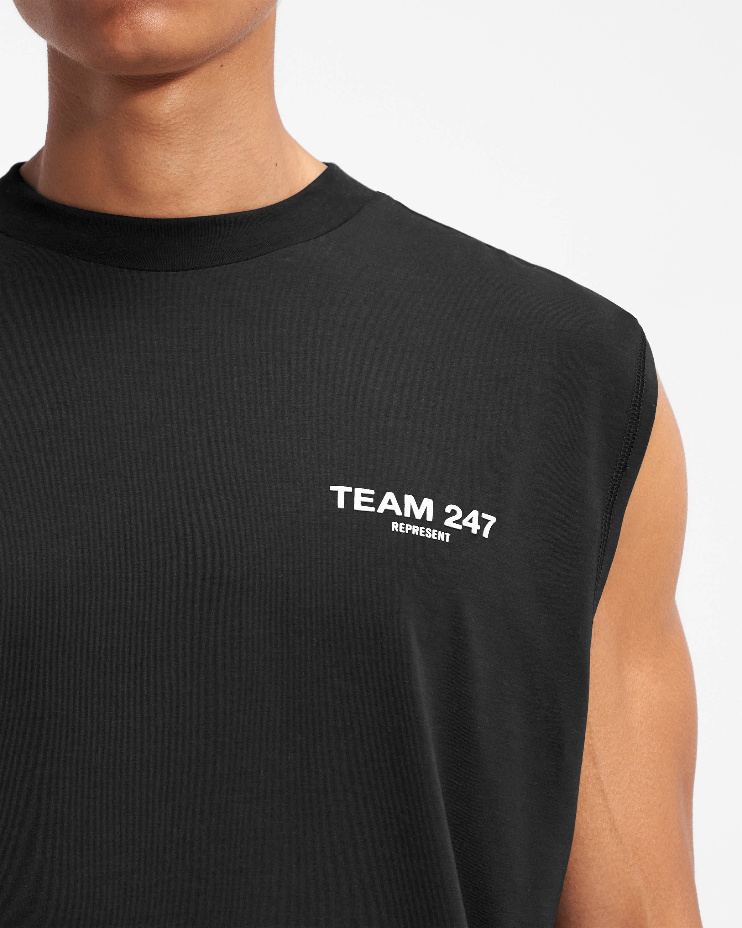 Man wearing a black oversized tank on a plain white background | Team 247 Oversized Tank in Black | Oversized tank top with 4-way stretch and breathable fabric | 247 T-Shirts | Represent Clo