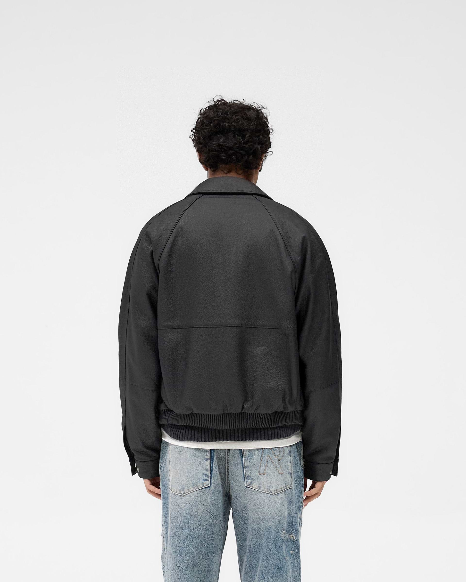 Man wearing a black leather jacket on a plain white background | Overdrive Leather Jacket in Black | Leather jacket with oversized fit and logo zip | SS25 Outerwear | Represent Clo