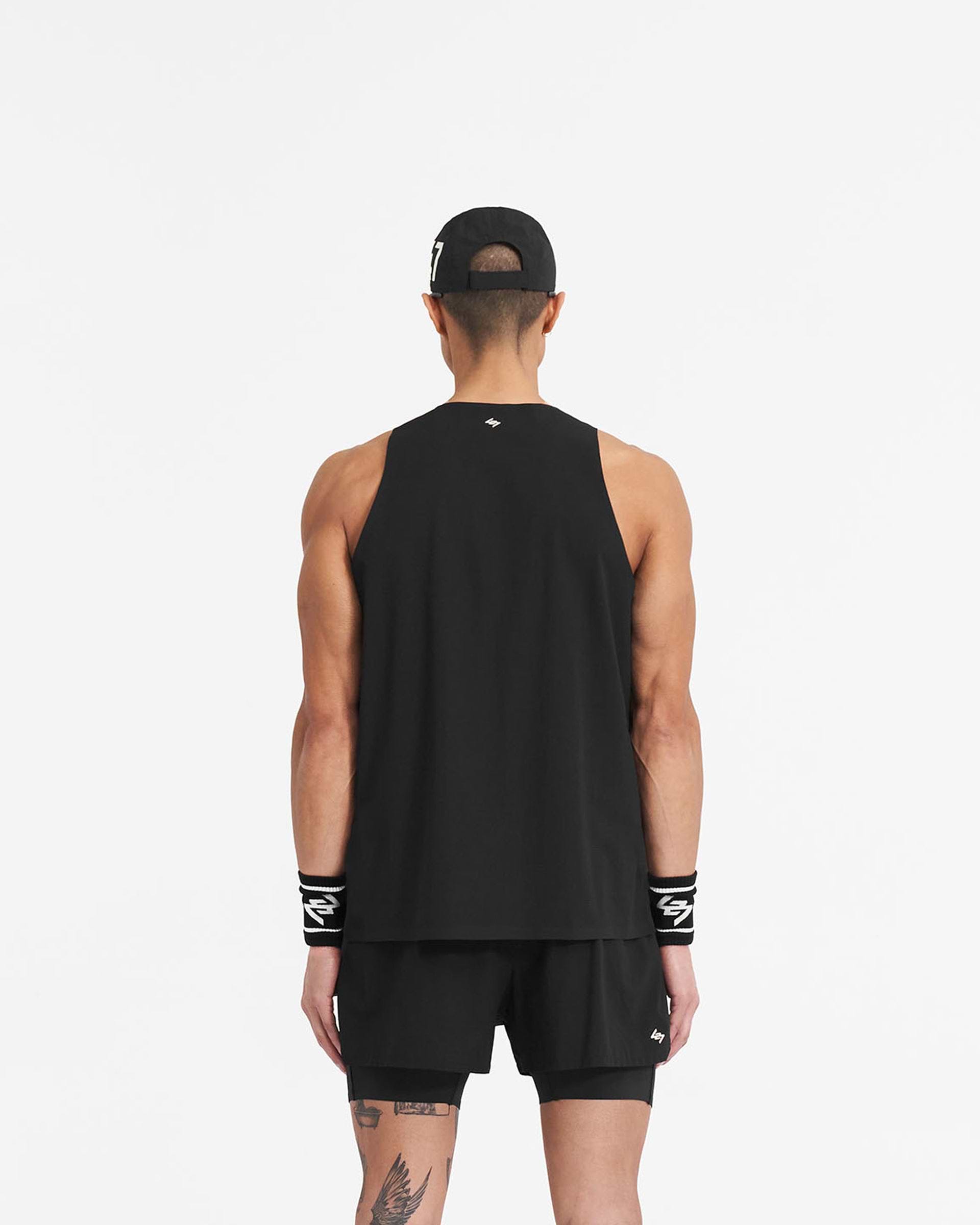 Man wearing a black vest on a plain white background | 247 Singlet in Jet Black | Perforated training vest with stretch ripstop fabric | 247 T-Shirts | Represent Clo