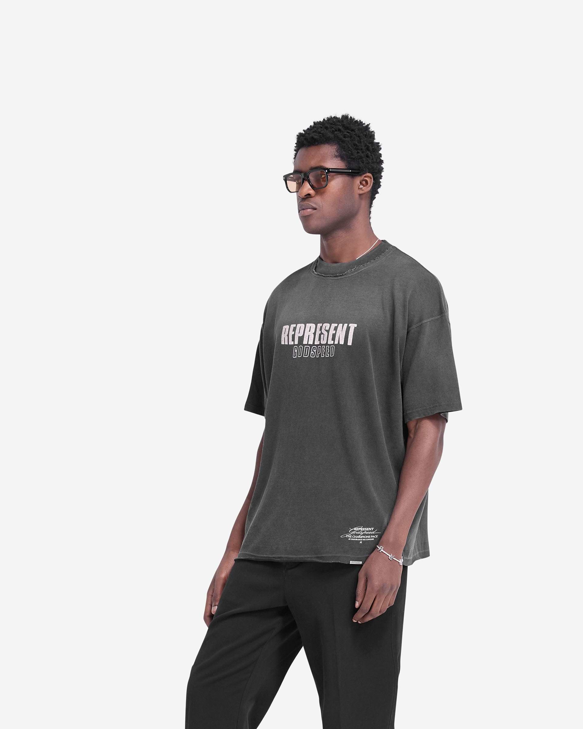 Man wearing a black t-shirt on a plain white background | Godspeed T-Shirt in Aged Black | Oversized t-shirt with fade out wash and cracked graphics | FW24 T-Shirts | Represent Clo