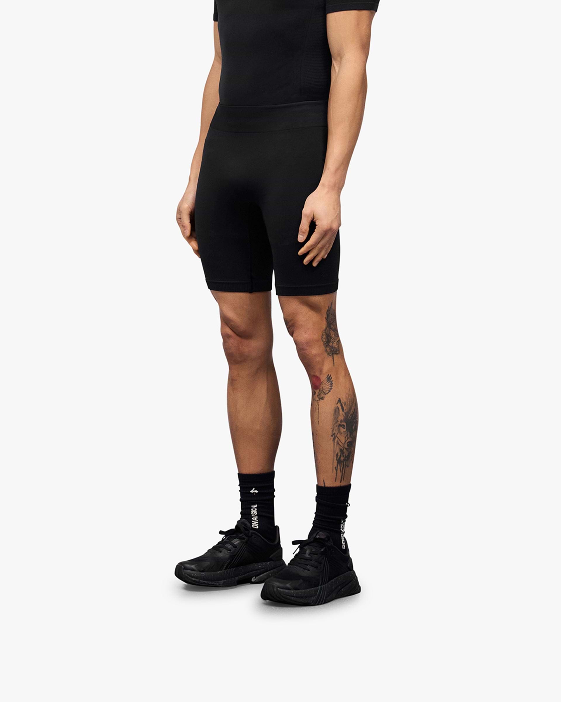 Back product image of mens black shorts on a plain white background | 247 DNA Seamless Shorts in Black | Fully seamless half tight shorts with flatlock stitching | 247 Shorts | Represent Clo