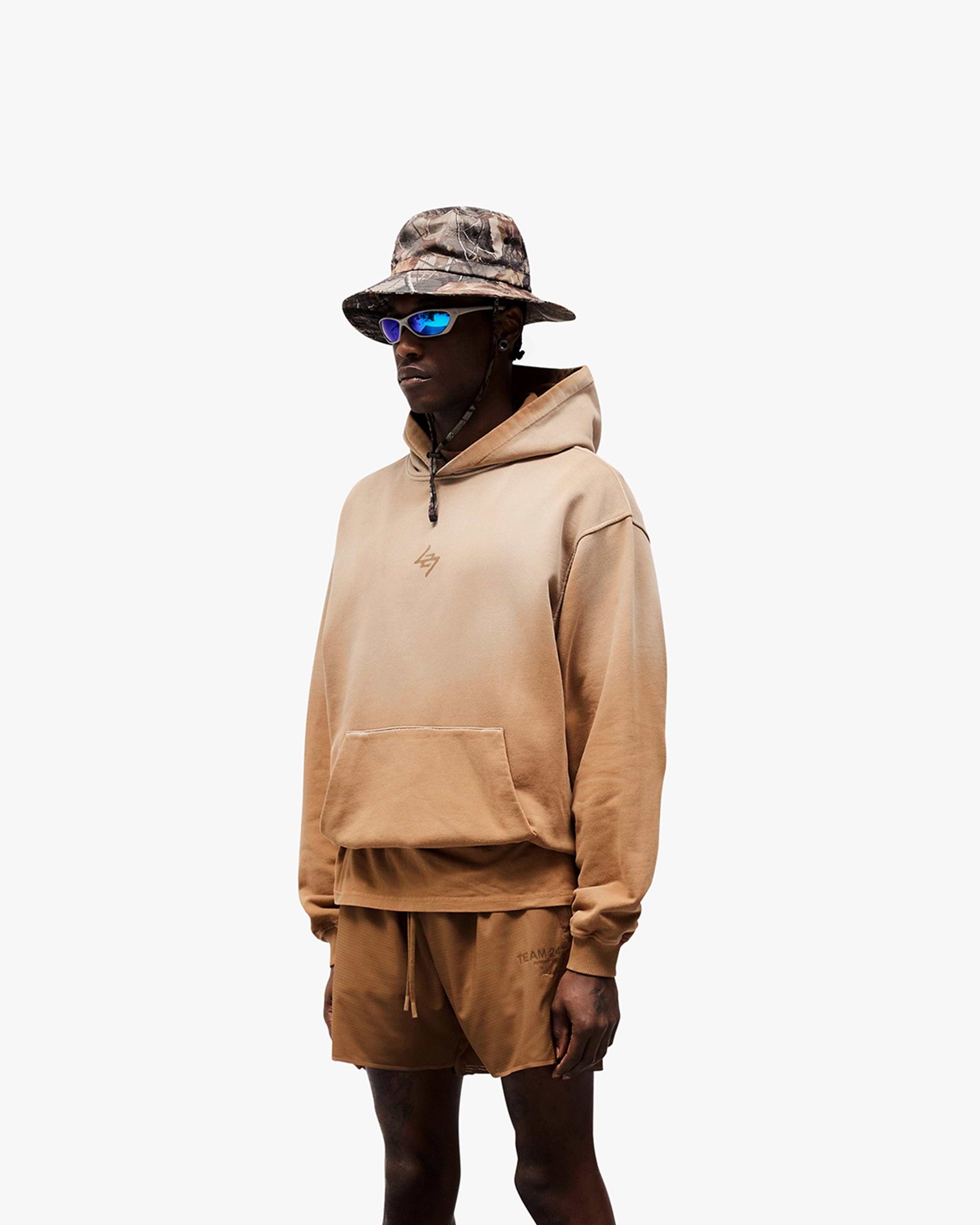 Man wearing an oversized rust hoodie on a plain white background | 247 Motion Oversized Hoodie in Rust | Oversized hoodie with ribbed hem and cuffs | 247 Hoodies | Represent Clo
