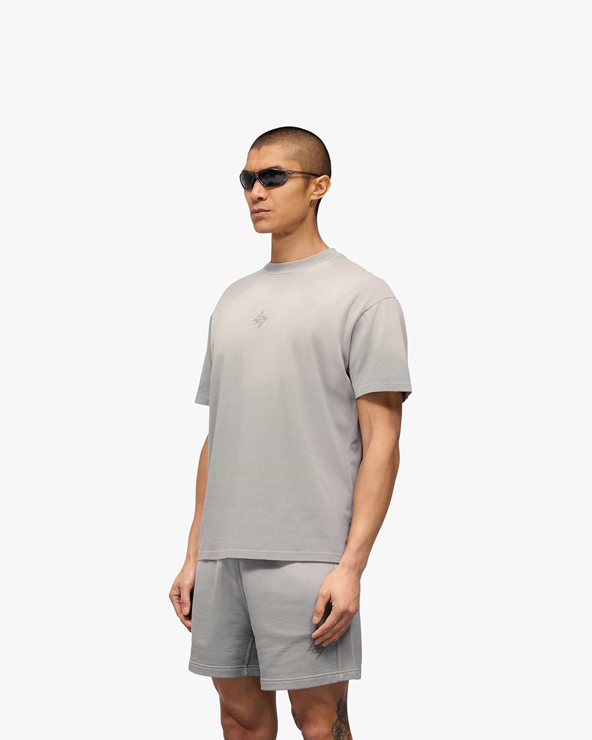 Man wearing an oversized grey t-shirt on a plain white background | 247 Motion Oversized T-Shirt in Titanium | Oversized t-shirt | 247 T-Shirts | Represent Clo