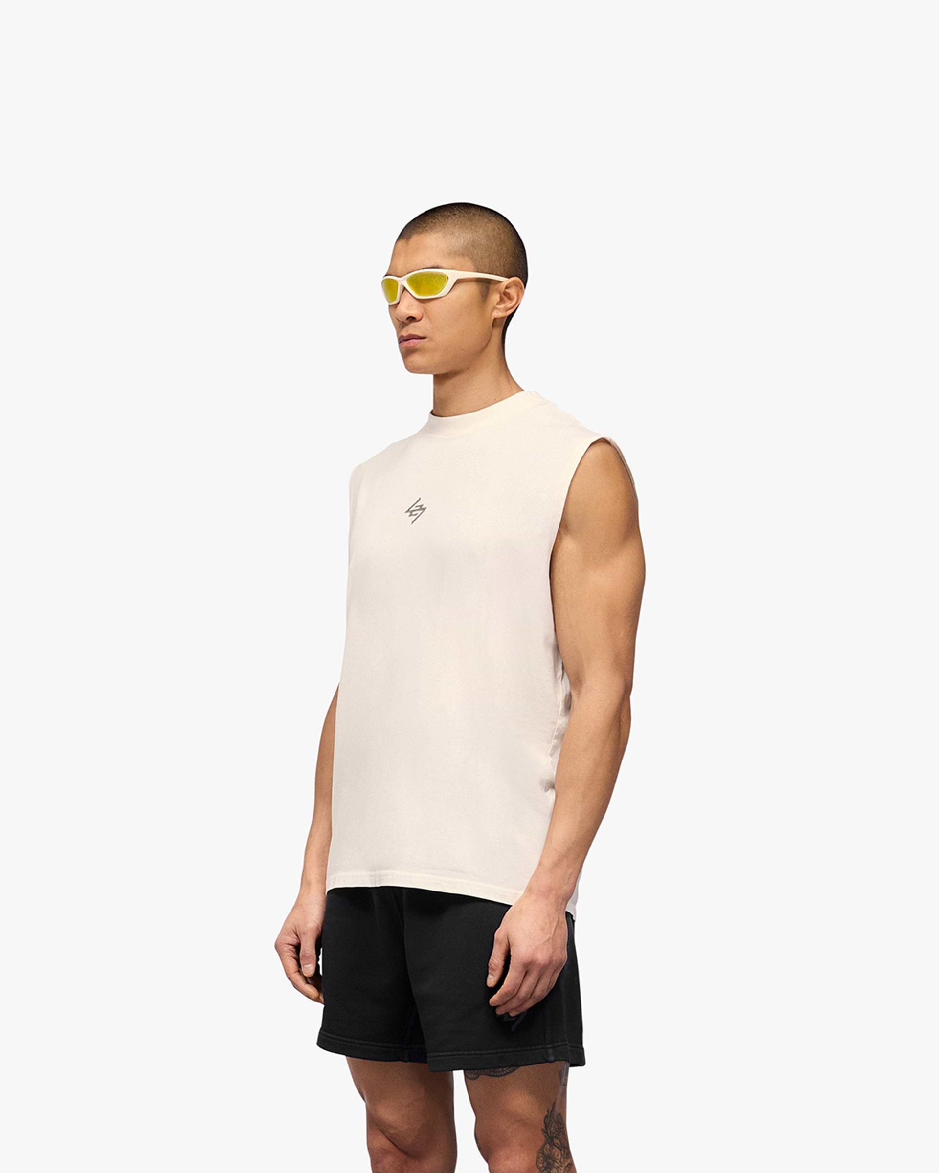 Man wearing a white tank on a plain white background | 247 Motion Oversized Tank in Flat White | Oversized tank with 2 way stretch and sweat wicking capability | 247 T-Shirts | Represent Clo