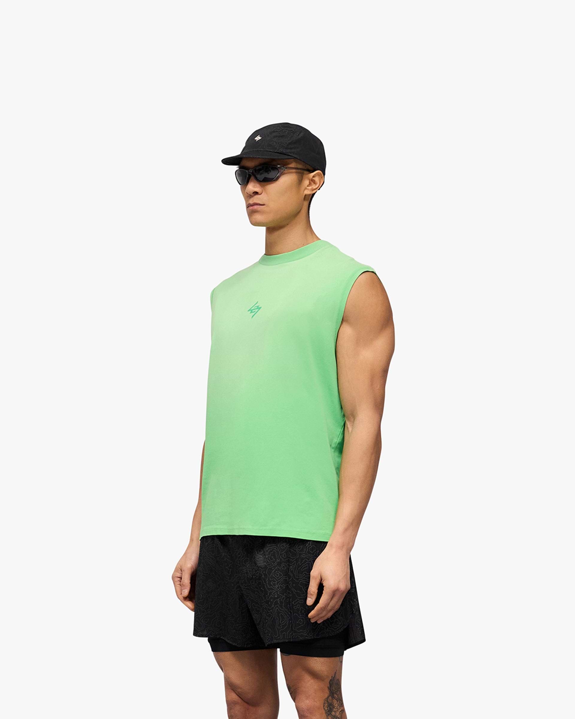 Man wearing a green oversized tank top on a plain white background | 247 Motion Oversized Tank in Speed Green | Oversized tank top with sweat wicking and antibacterial properties | 247 T-Shirts | Represent Clo