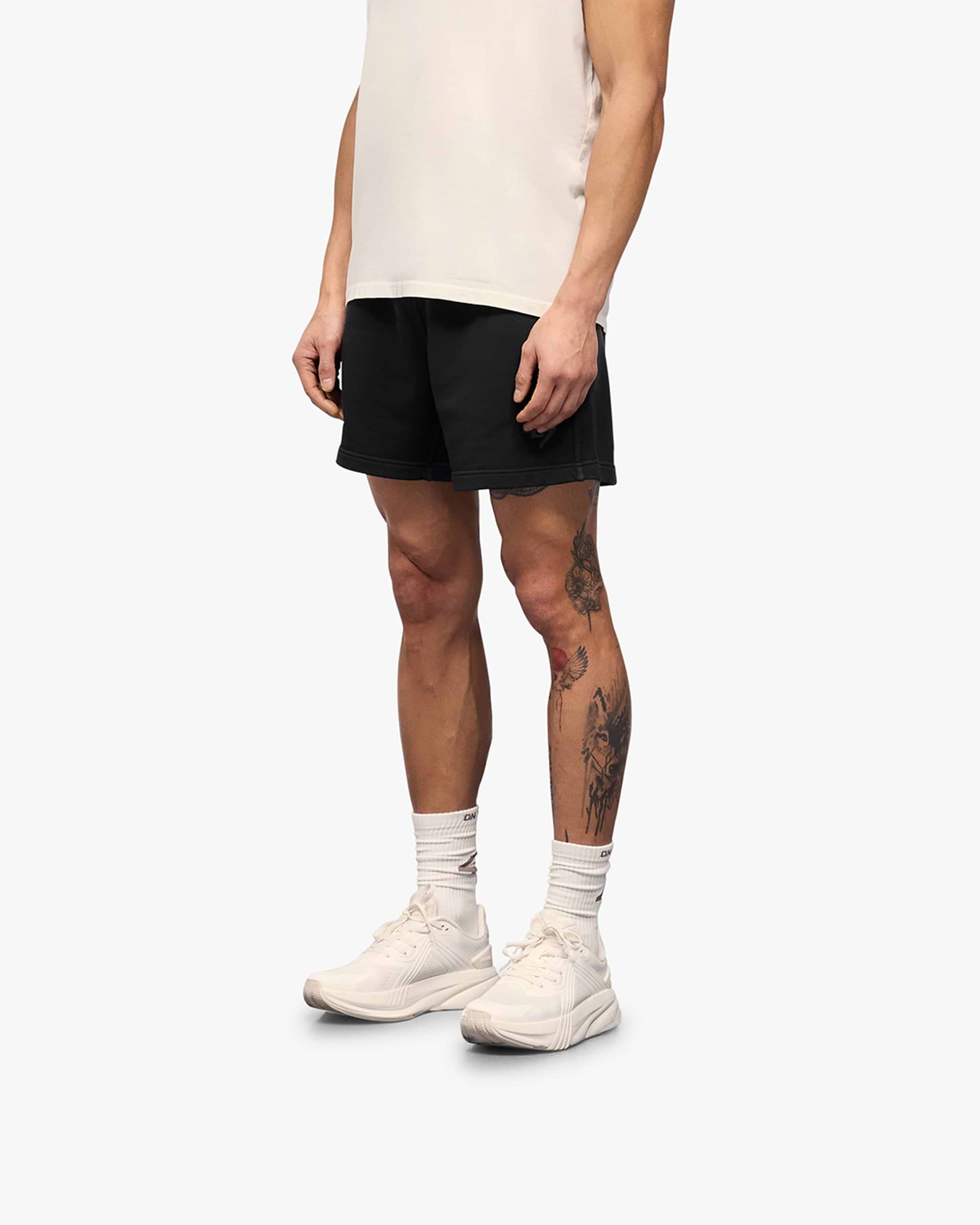 Back product image of mens black shorts on a plain white background | 247 Motion Shorts in Aged Black | Jersey shorts with elasticated waistband | 247 Shorts | Represent Clo