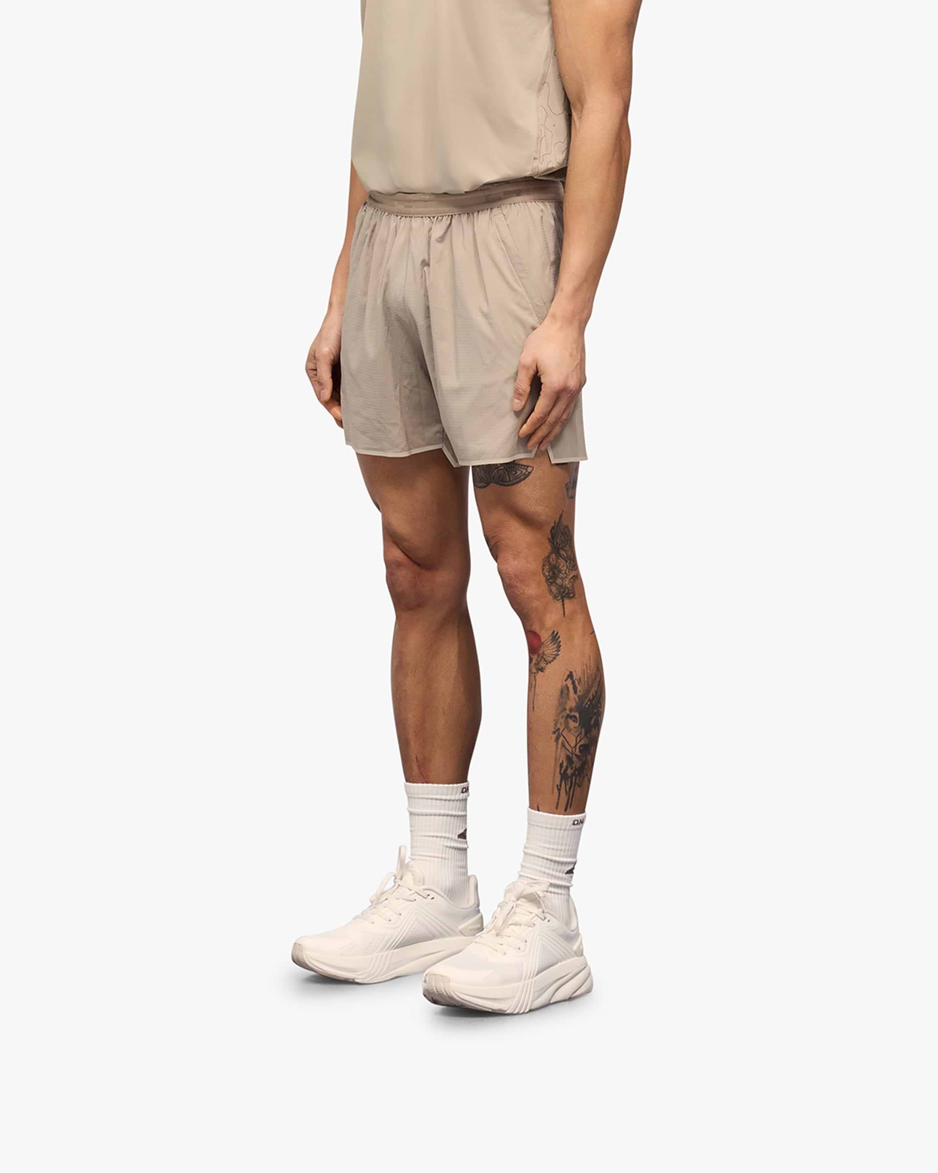 Back product image of mens grey shorts on a plain white background | Team 247 Aero Shorts in Pebble | Lightweight breathable shorts with branded zip pockets | 247 Shorts | Represent Clo