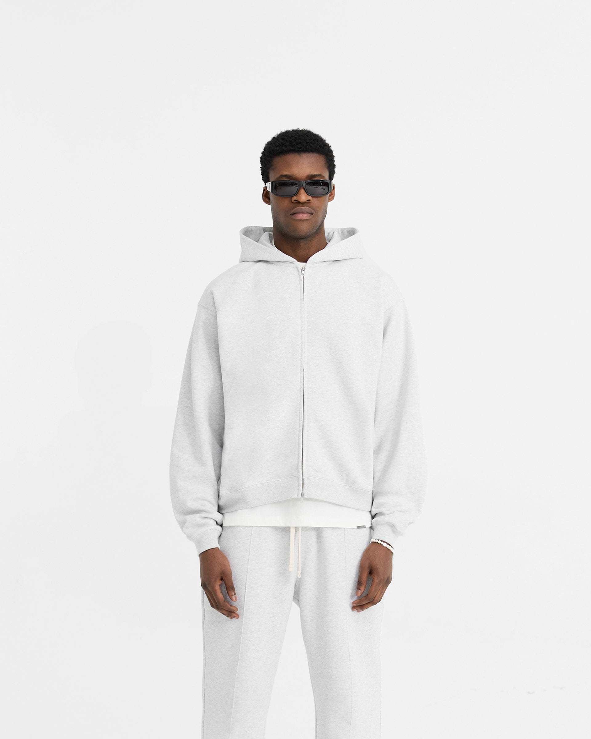 Man wearing an oversized grey zip hoodie on a plain white background | Initial Oversized Zip Hoodie in Ice Grey Marl | Heavyweight loopback jersey with side seam pockets | Initial Hoodies | Represent Clo