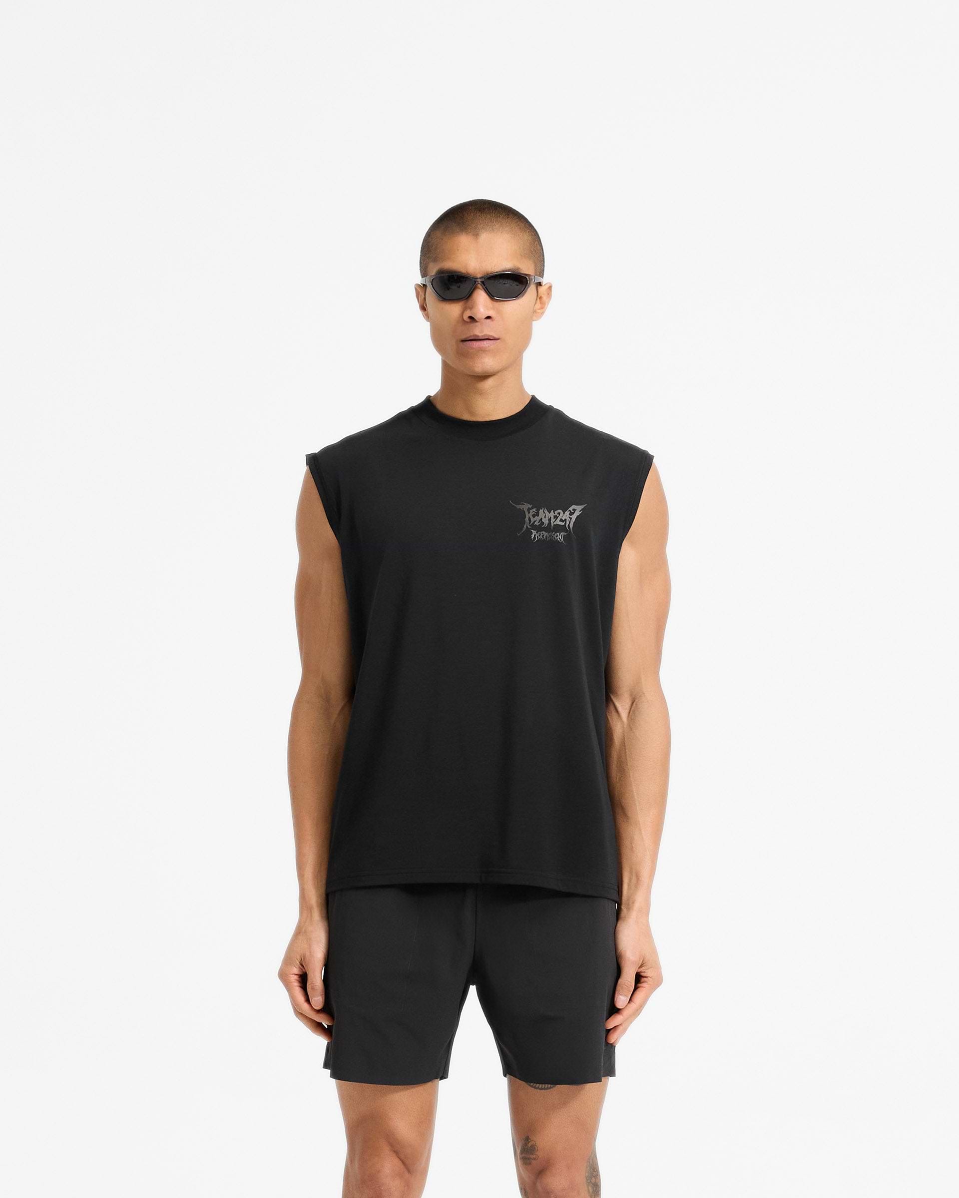 Man wearing an oversized black tank on a plain white background | Team 247 X END Oversized Tank in Jet Black | Oversized tank with Drirelease fabric and co-branded graphics | 247 T-Shirts | Represent Clo