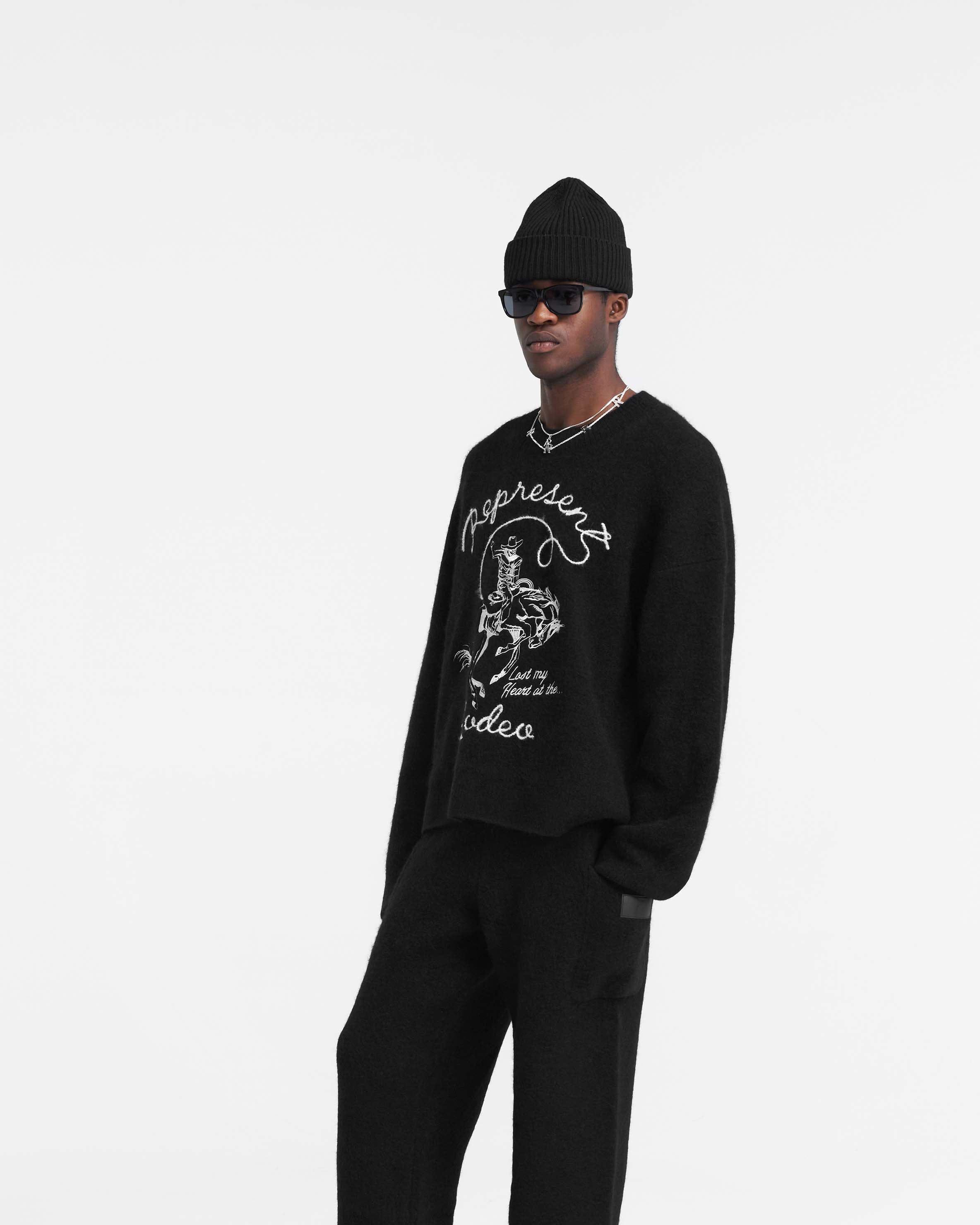 Back product image of a mens black sweater on a plain white background | Western Knit Sweatshirt in Jet Black | Knit sweater with embroidered rodeo design | PRE SS24 Knitwear | Represent Clo
