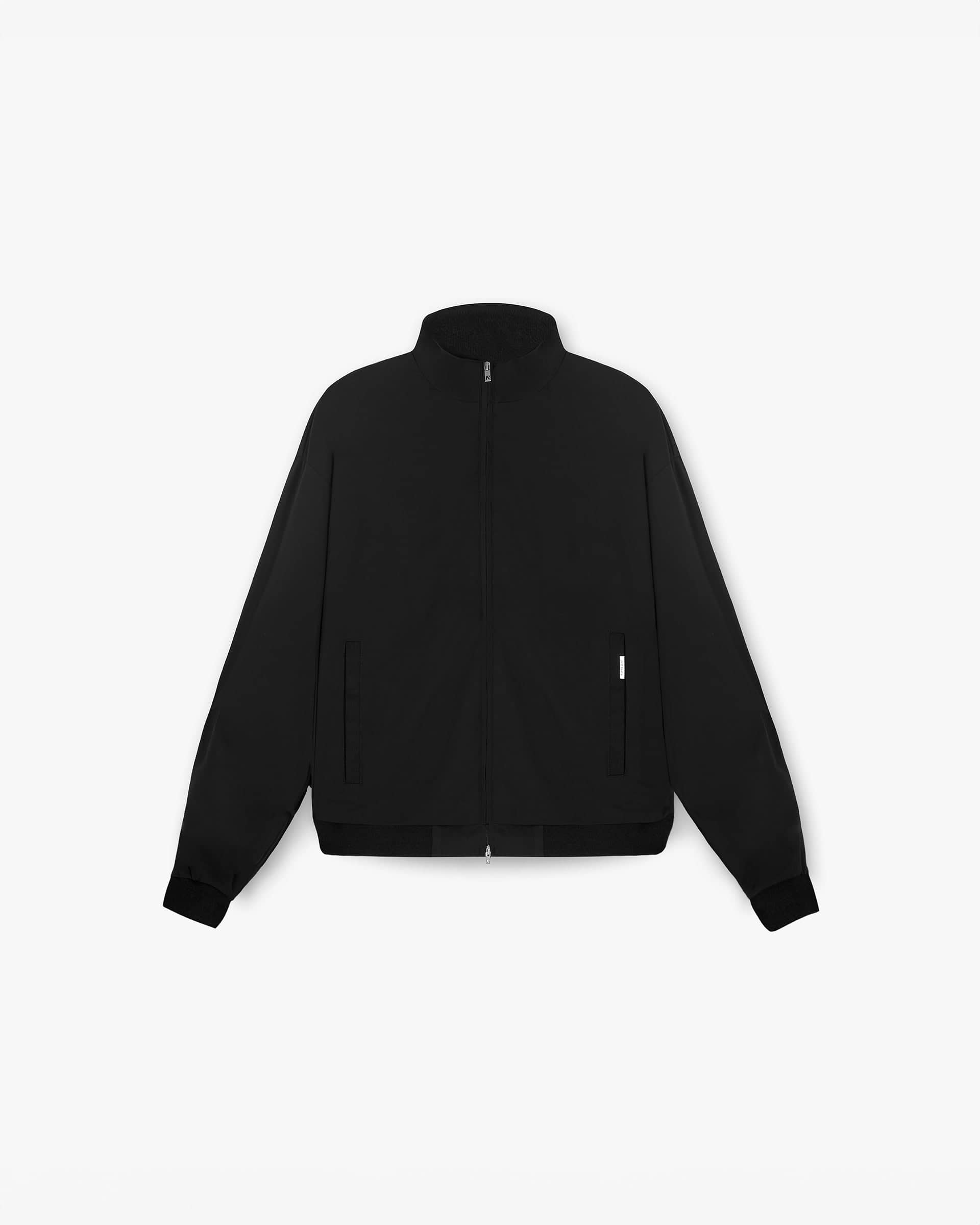 Front product image of a mens black track jacket on a plain white background | Initial Track Jacket in Black | Black track jacket with ribbed trims and cobrax poppers | Initial Outerwear | Represent Clo