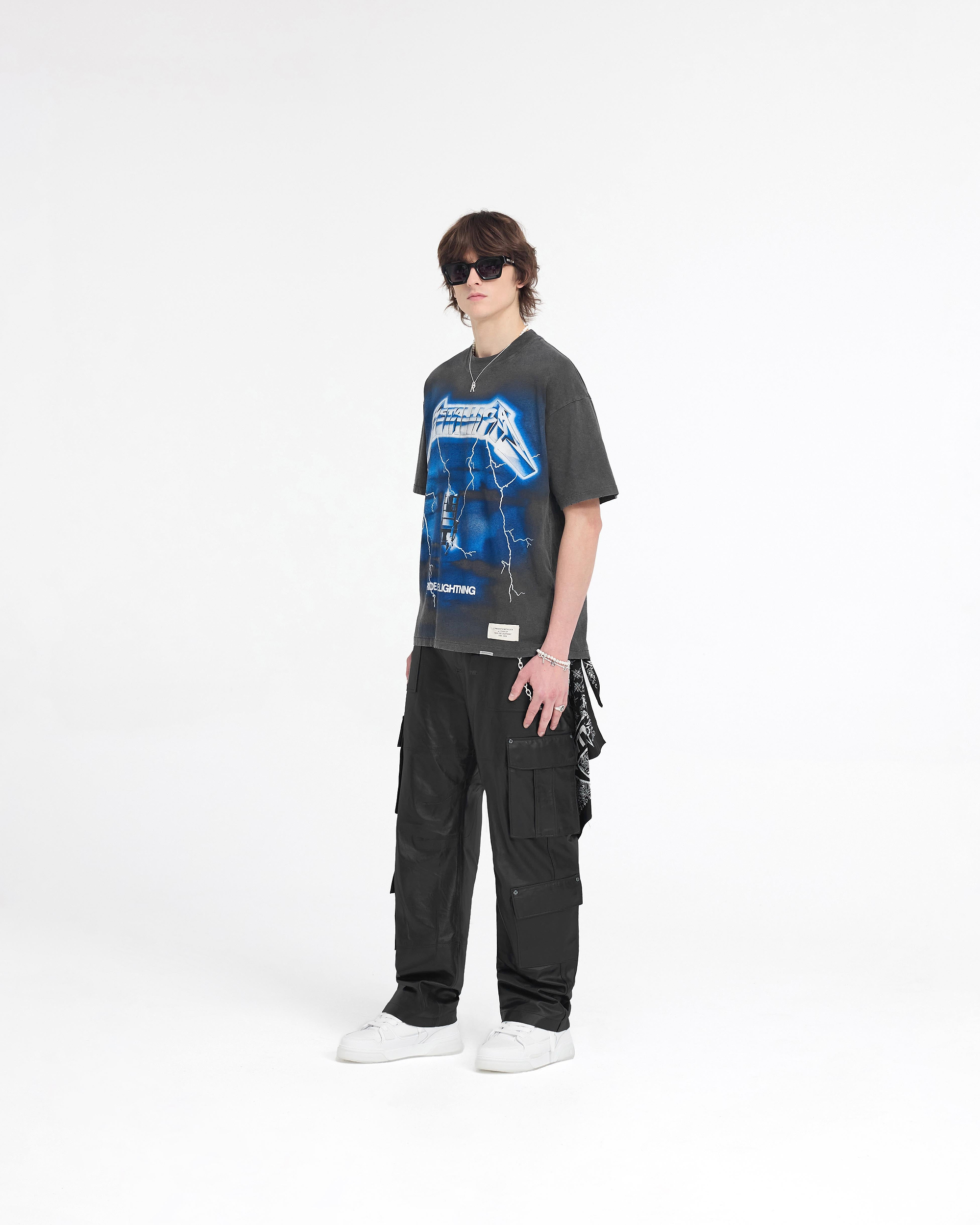 Man wearing a vintage grey t-shirt on a plain white background | Represent X Metallica Ride The Lightning T-Shirt in Vintage Grey | T-shirt with screen print graphics and anniversary patch | SS24 T-Shirts | Represent Clo