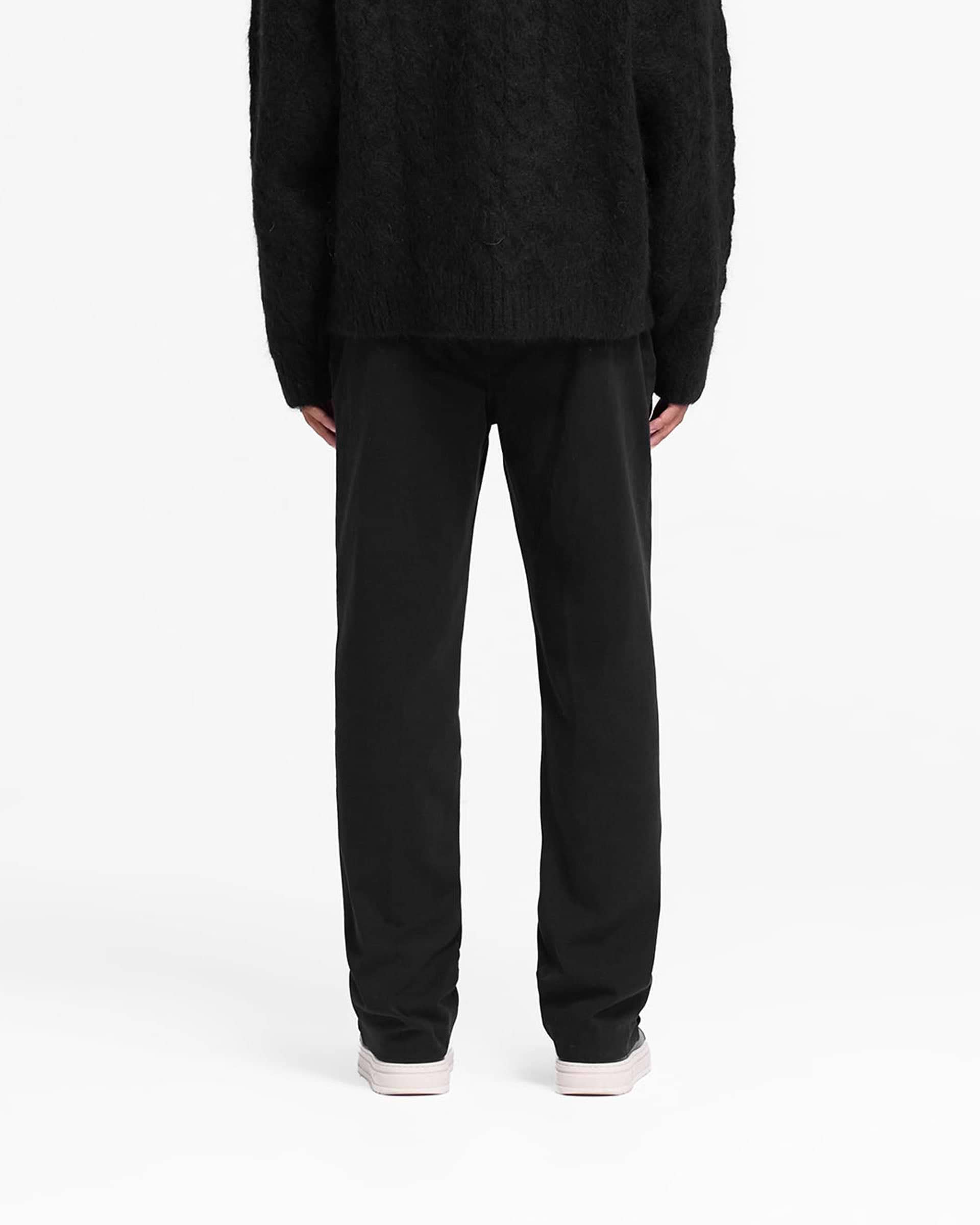 Man wearing a black pant on a plain white background | Cotton Pant in Black | Straight leg cotton twill pants with side and back pockets | FW24 Pants | Represent Clo