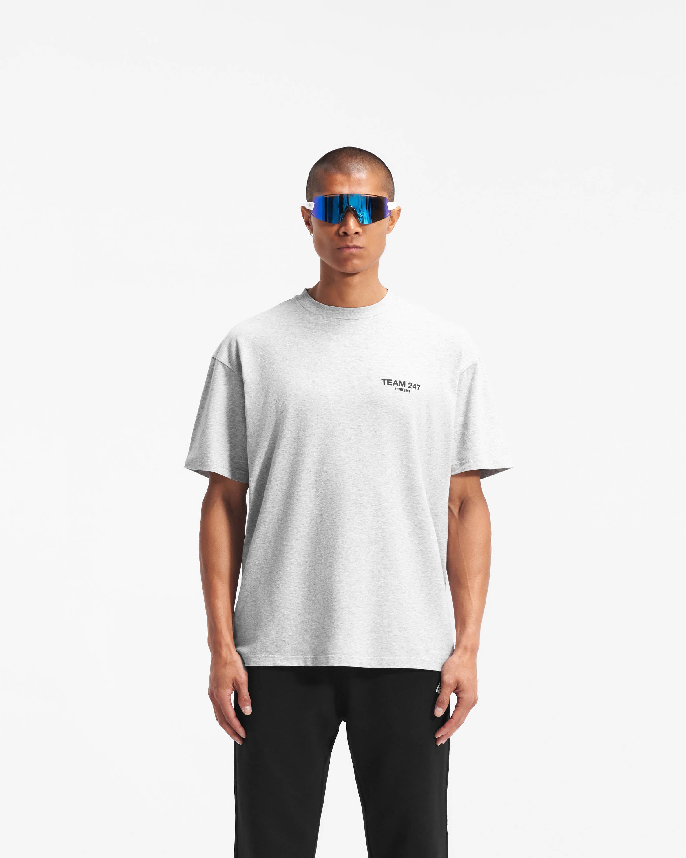 Man wearing an oversized grey t-shirt on a plain white background | Team 247 Oversized T-Shirt in Ash Grey | Lightweight breathable gym t-shirt with 4-way stretch | 247 T-Shirts | Represent Clo