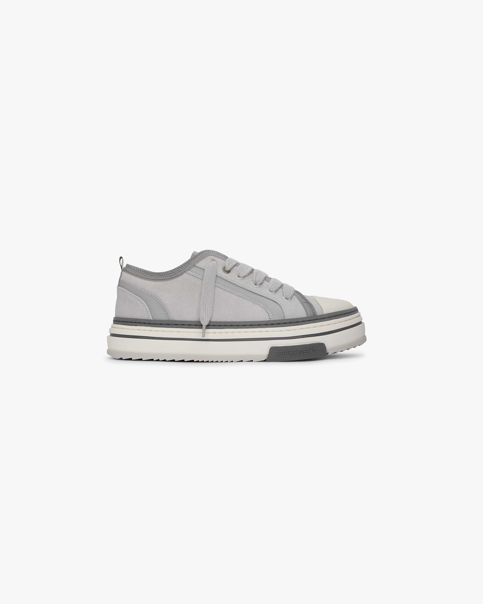 Front product image of mens grey low-top sneakers on a plain white background | HTN X Low in Warm Grey | Low-top sneakers with comfort and style | SS24 Footwear | Represent Clo