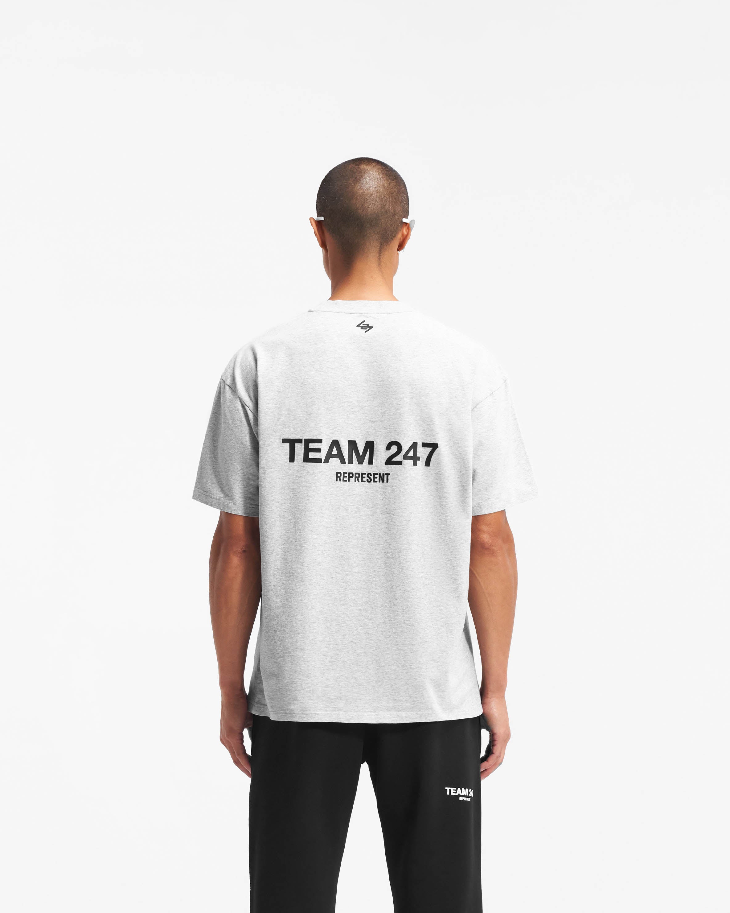 Man wearing an oversized grey t-shirt on a plain white background | Team 247 Oversized T-Shirt in Ash Grey | Lightweight breathable gym top | 247 T-Shirts | Represent Clo