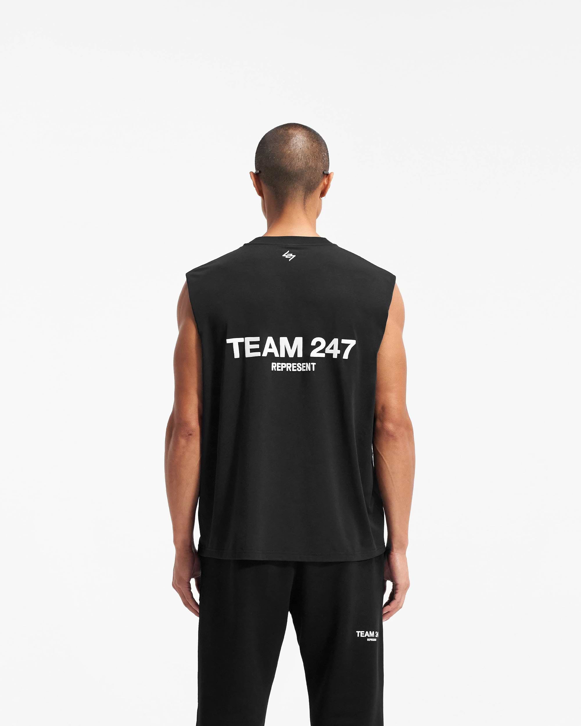 Man wearing a black tank top on a plain white background | Team 247 Oversized Tank in Black | Lightweight breathable oversized tank | 247 T-Shirts | Represent Clo