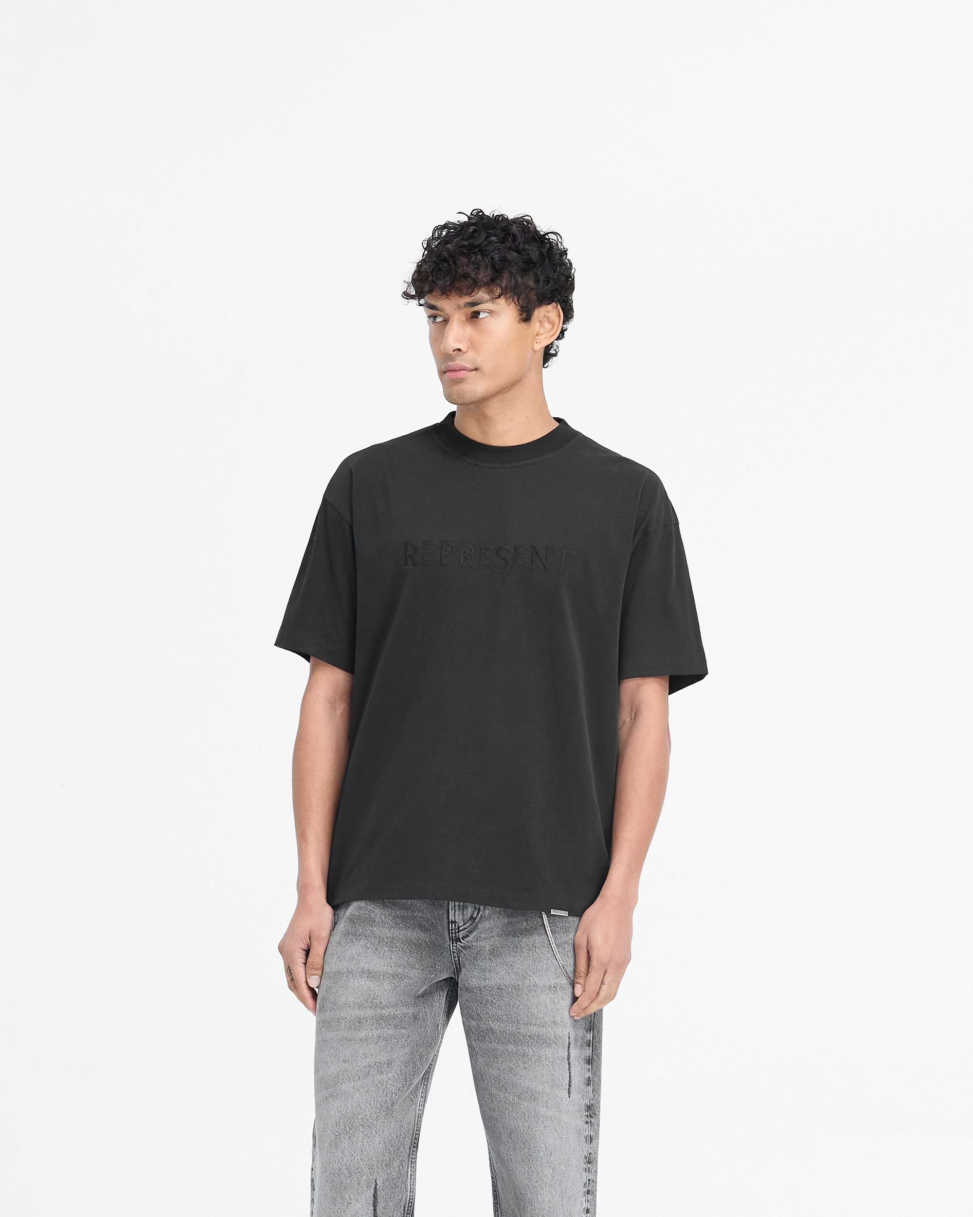 Back product image of a mens black t-shirt on a plain white background | Serif Logo T-Shirt in Jet Black | Oversized t-shirt with embroidered branding | PRE SS25 T-Shirts | Represent Clo