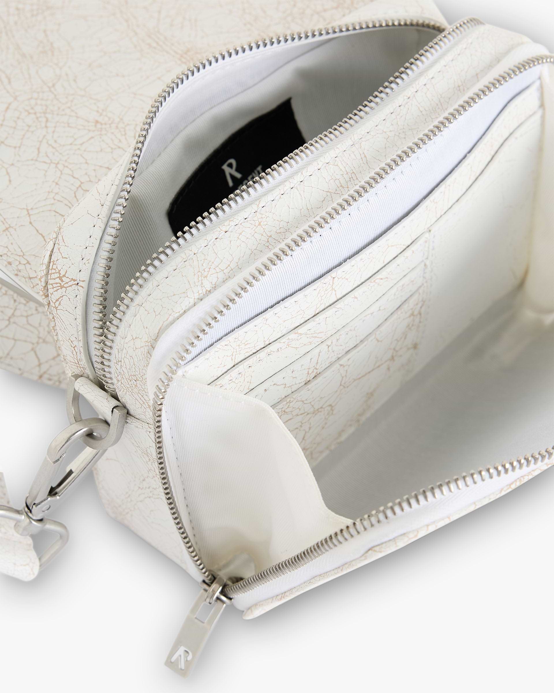 Back product image of a mens white cross body bag on a plain white background | Cracked Leather Cross Body Bag in Antique White | 100 percent cracked leather bag with adjustable strap | SC24 Accessories | Represent Clo