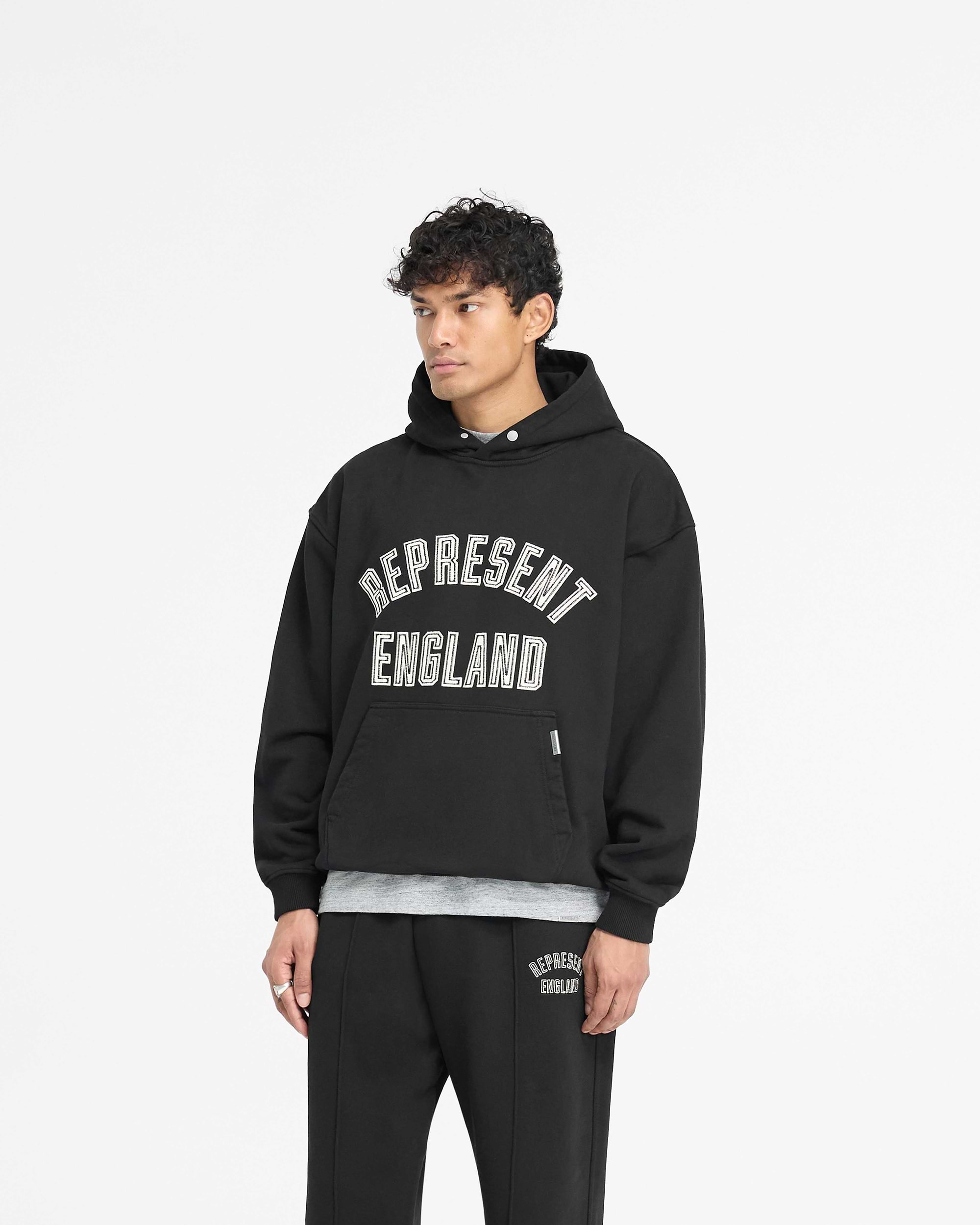 Back product image of a mens black hoodie on a plain white background | England Applique Hoodie in Jet Black | Slightly oversized hoodie with applique embroidery | PRE SS25 Hoodies | Represent Clo