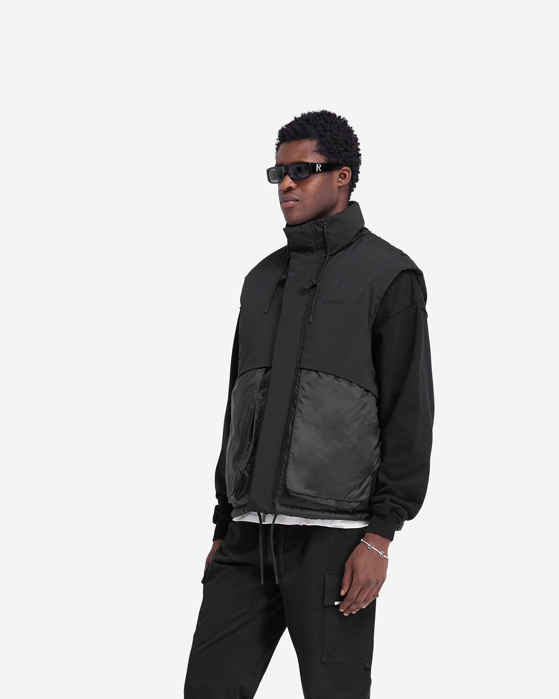 Back product image of a mens black puffer gilet on a plain white background | Layered Puffer Gilet in Jet Black | Duck down filled gilet with adjustable hem and storm flaps | FW24 Outerwear | Represent Clo