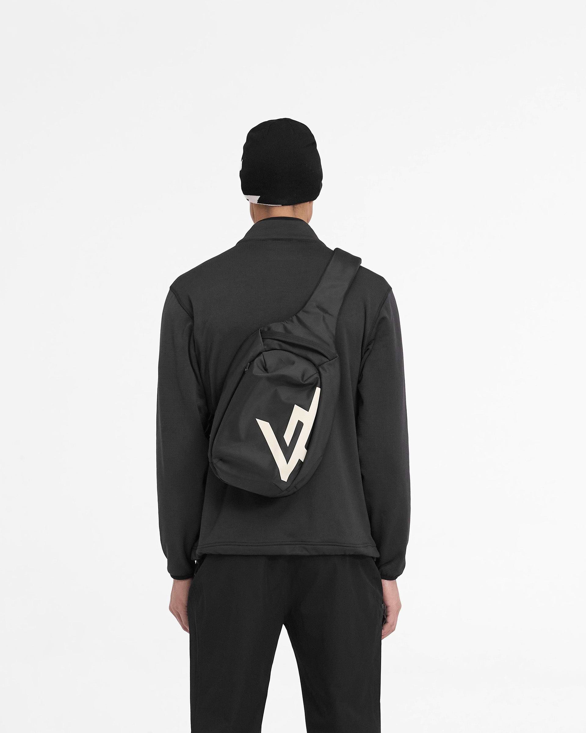 Man wearing a black zip fleece jacket on a plain white background | 247 Full Zip Fleece in Black | Fleece jacket with zip chest pocket and adjustable hem | 247 Outerwear | Represent Clo