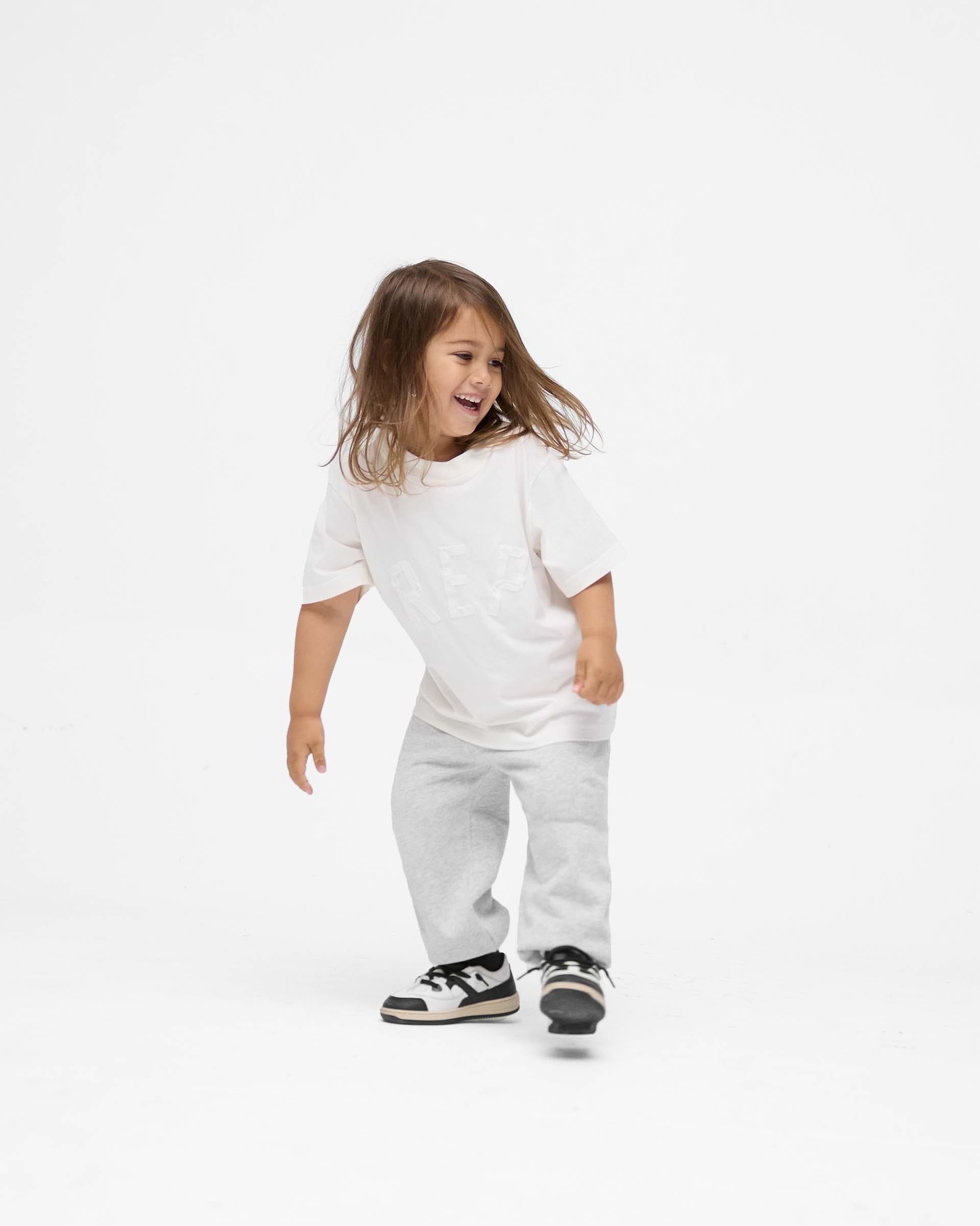 Back product image of a child's white t-shirt on a plain white background | Mini Rep Applique T-Shirt in Flat White | Organic cotton oversized t-shirt | FW24 T-Shirts | Represent Clo