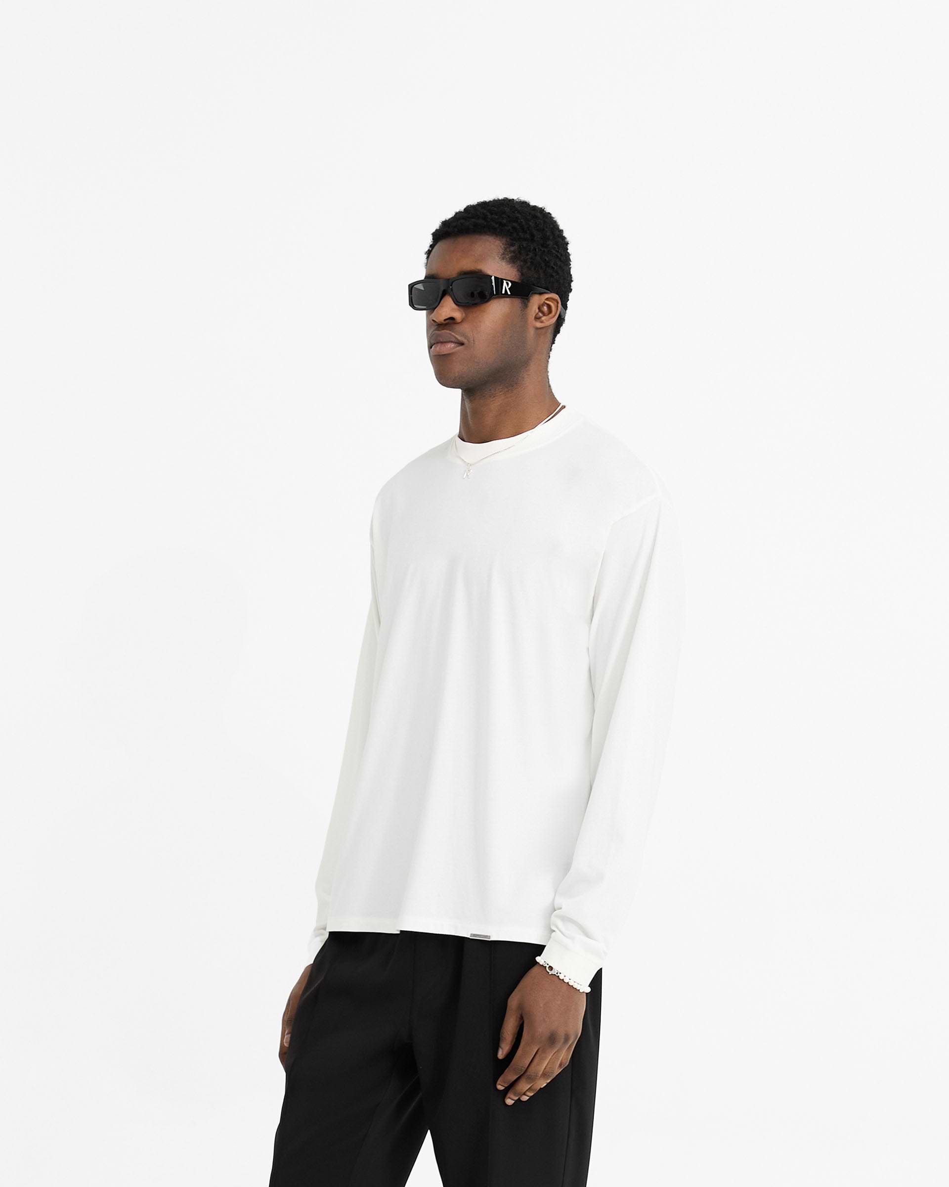 Back product image of a mens white long sleeve t-shirt on a plain white background | Initial Long Sleeve T-Shirt in Flat White | Regular fit long sleeve t-shirt with embroidered Initial and metal bar | Initial T-Shirts | Represent Clo