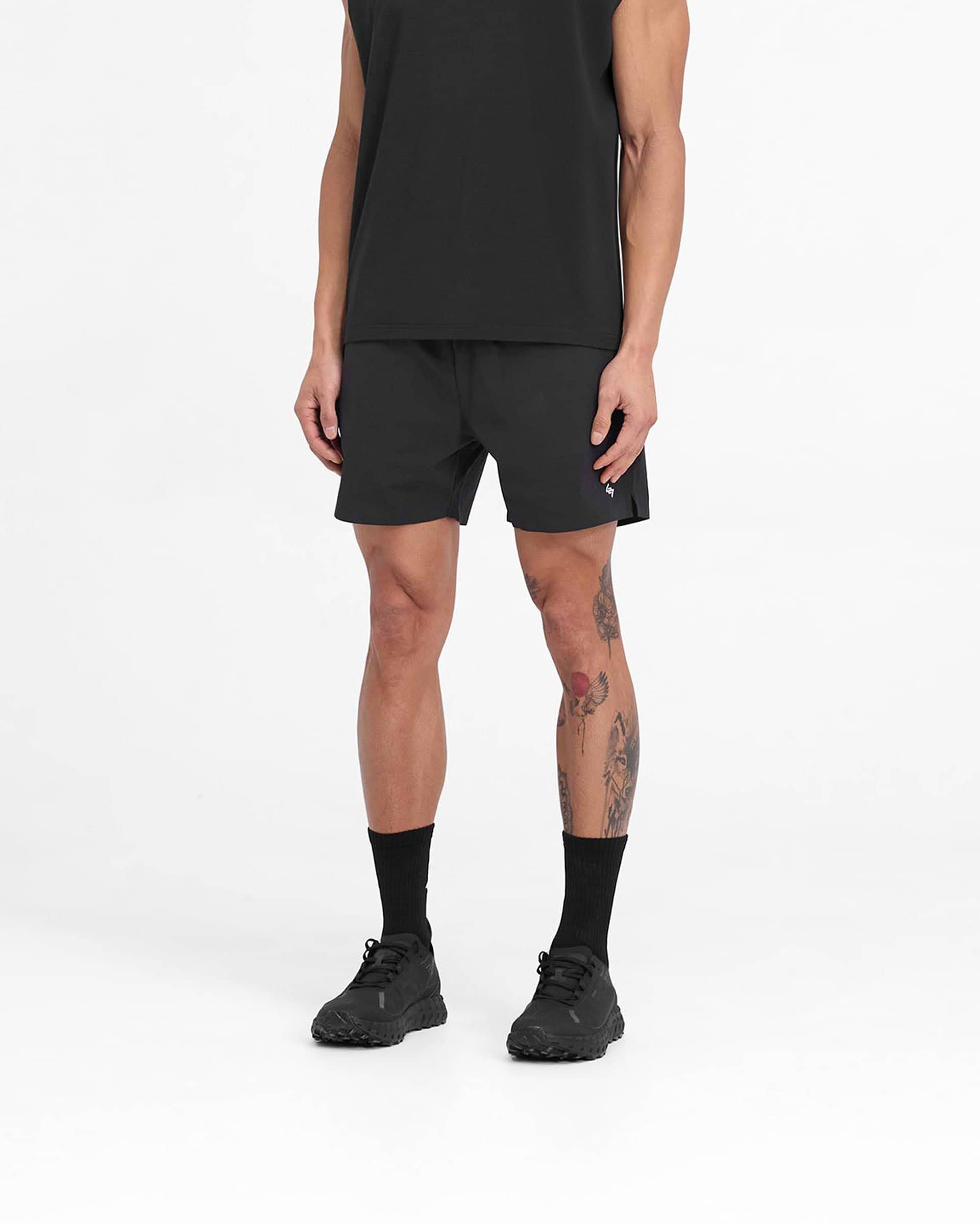 Man wearing black shorts on a plain white background | Team 247 Fused Shorts in Black | Shorts with 4-way stretch and branded waistband | 247 Shorts | Represent Clo