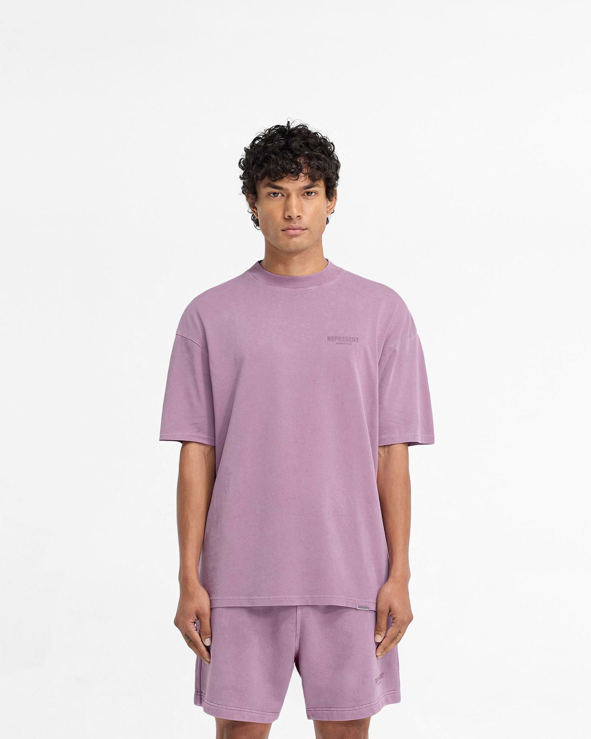 Man wearing a purple short sleeve t-shirt on a plain white background | Represent Owners Club T-Shirt in Mid Purple | Jersey t-shirt with ribbed crewneck and tonal branding | Owners Club T-Shirts | Represent Clo