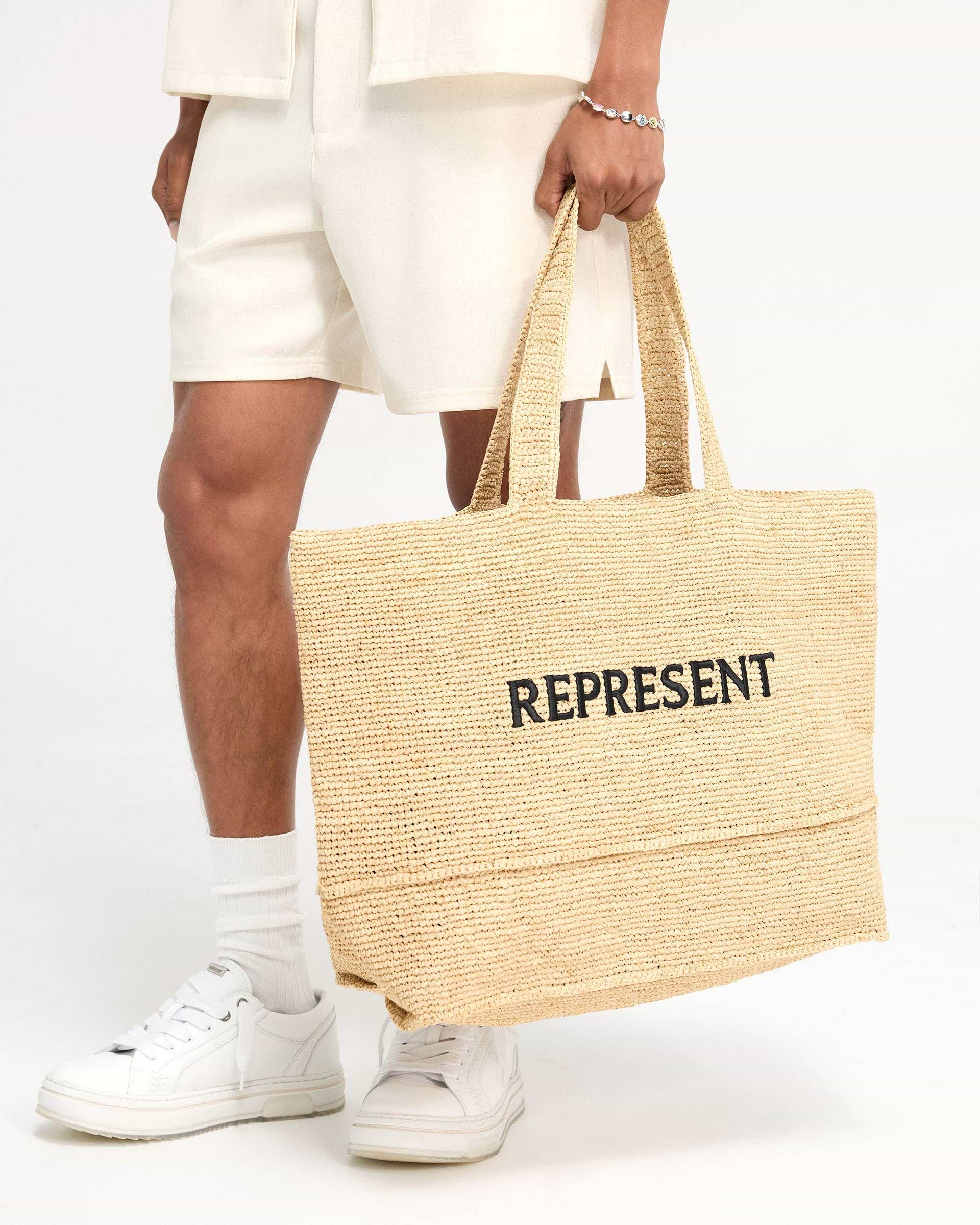 Back product image of a latte bag on a plain white background | Raffia Tote Bag in Latte | Large raffia bag with leather inner pocket | FW24 Accessories | Represent Clo