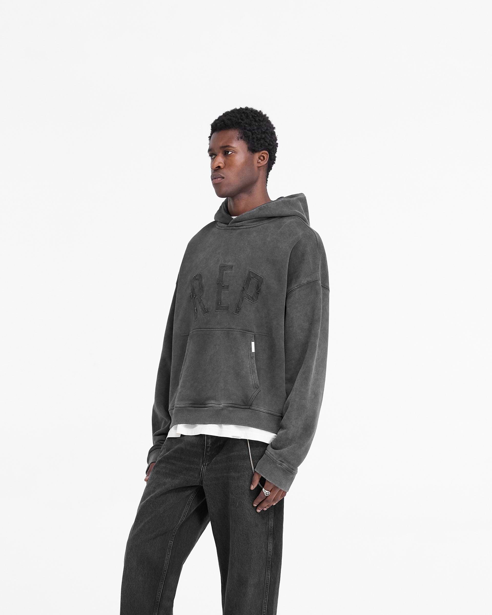 Back product image of a mens black hoodie on a plain white background | Rep Applique Hoodie in Vintage Black | Oversized boxy fit hoodie with ribbed hem and cuffs | FW24 Hoodies | Represent Clo