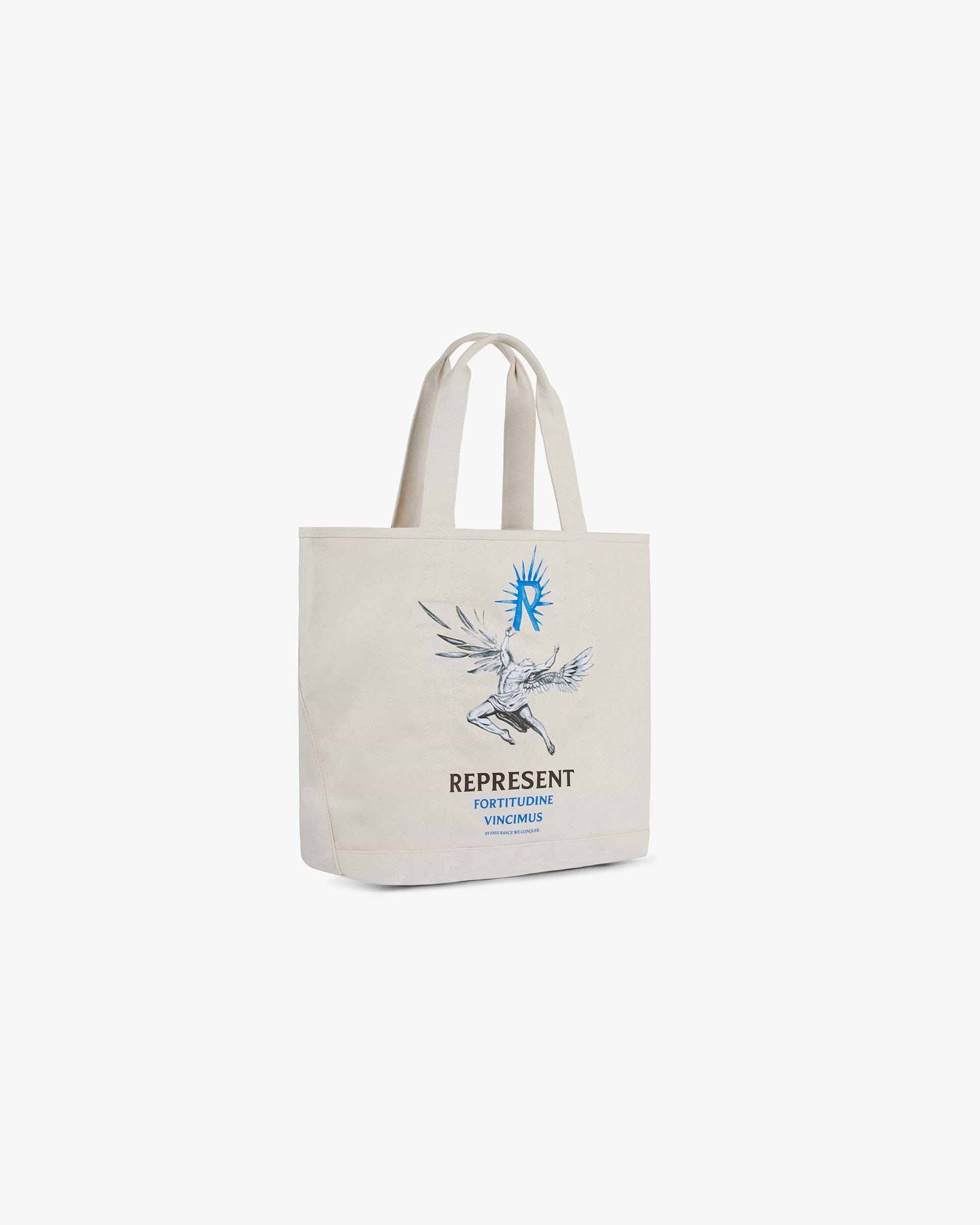 Back product image of a mens natural canvas tote bag on a plain white background | Icarus Tote Bag in Natural Canvas | Structured tote bag with reinforced bottom and screen printed graphic | SS24 Accessories | Represent Clo