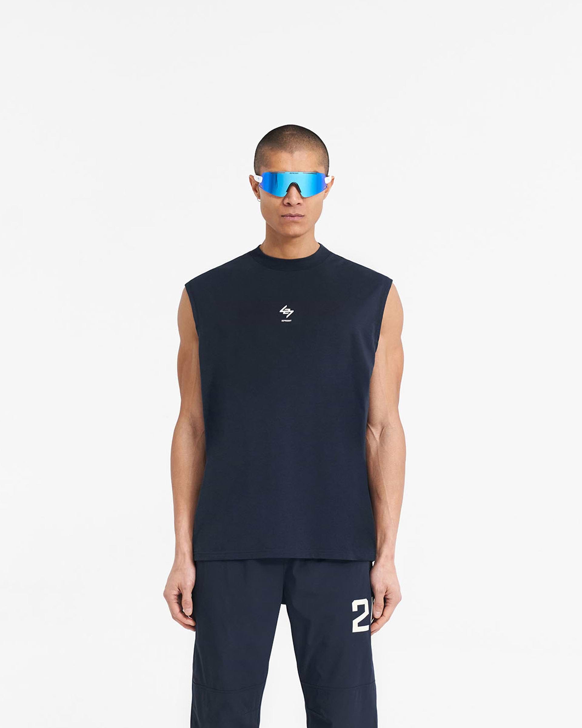 Man wearing a navy oversized tank top on a plain white background | 247 Oversized Tank in Navy | Lightweight tank with 4-way stretch and antibacterial finish | 247 T-Shirts | Represent Clo