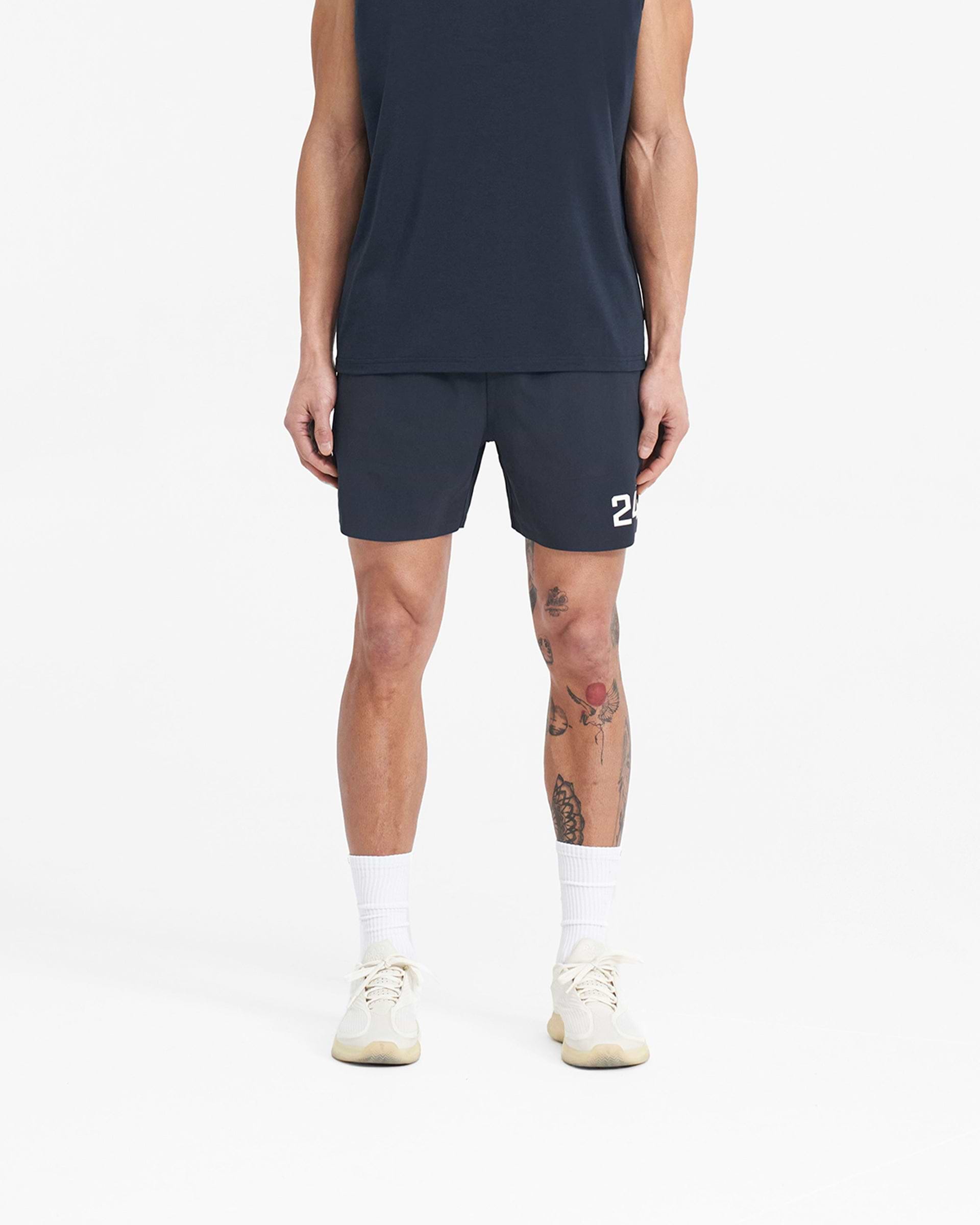 Man wearing navy shorts on a plain white background | 247 Fused Shorts in Navy | Gym shorts with 4 way stretch and branded waistband | 247 Shorts | Represent Clo
