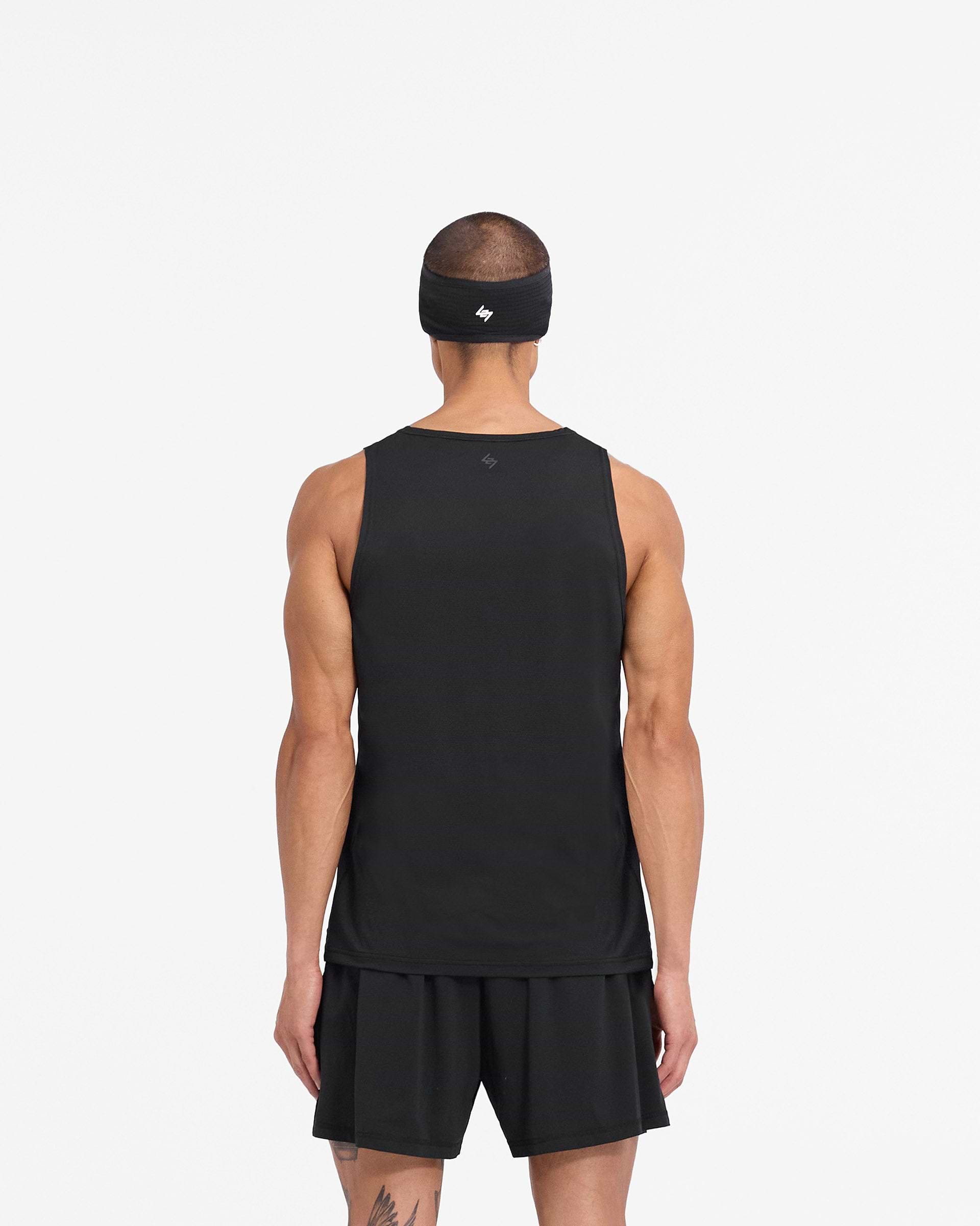 Man wearing a black vest on a plain white background | 247 DNA Mesh Vest in Black | Training vest with moisture-wicking fabric | 247 T-Shirts | Represent Clo