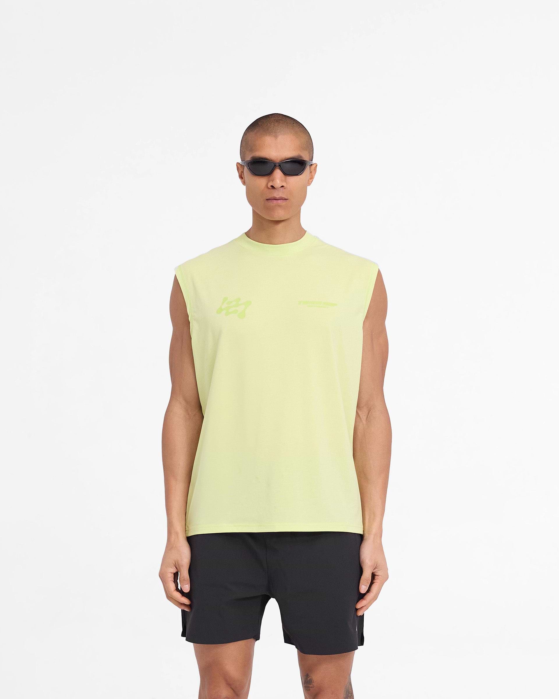Man wearing an oversized lime tank top on a plain white background | 247 Future Terrains Oversized Tank in Shadow Lime | Quick drying lightweight tank top with Drirelease fabric | 247 T-Shirts | Represent Clo