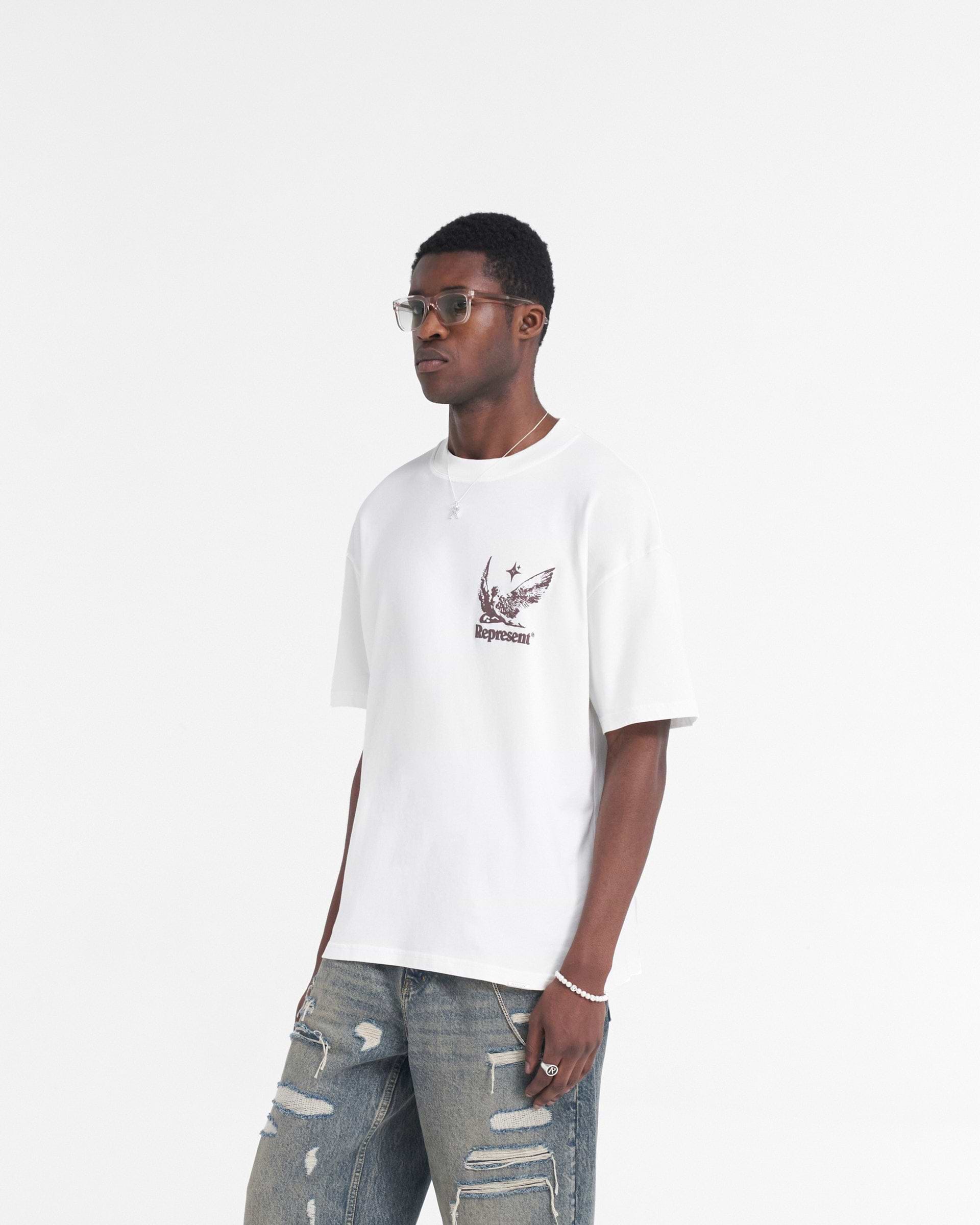 Man wearing a white t-shirt on a plain white background | Spirits Of Summer T-Shirt in Flat White | Oversized t-shirt with puff print graphic | SS24 T-Shirts | Represent Clo