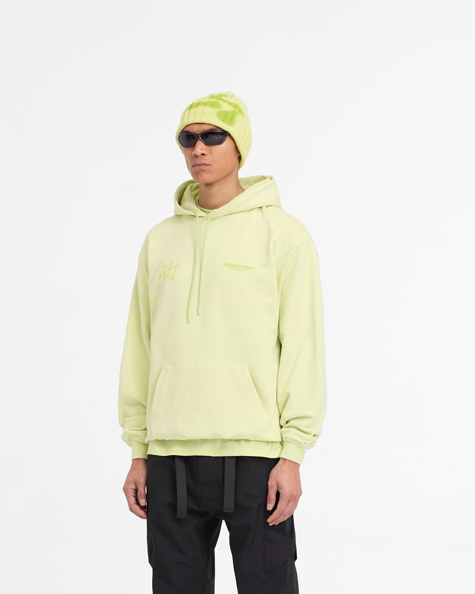 Man wearing an oversized green hoodie on a plain white background | 247 Future Terrains Oversized Hoodie in Shadow Lime | Heavyweight jersey hoodie with branding | 247 Hoodies | Represent Clo
