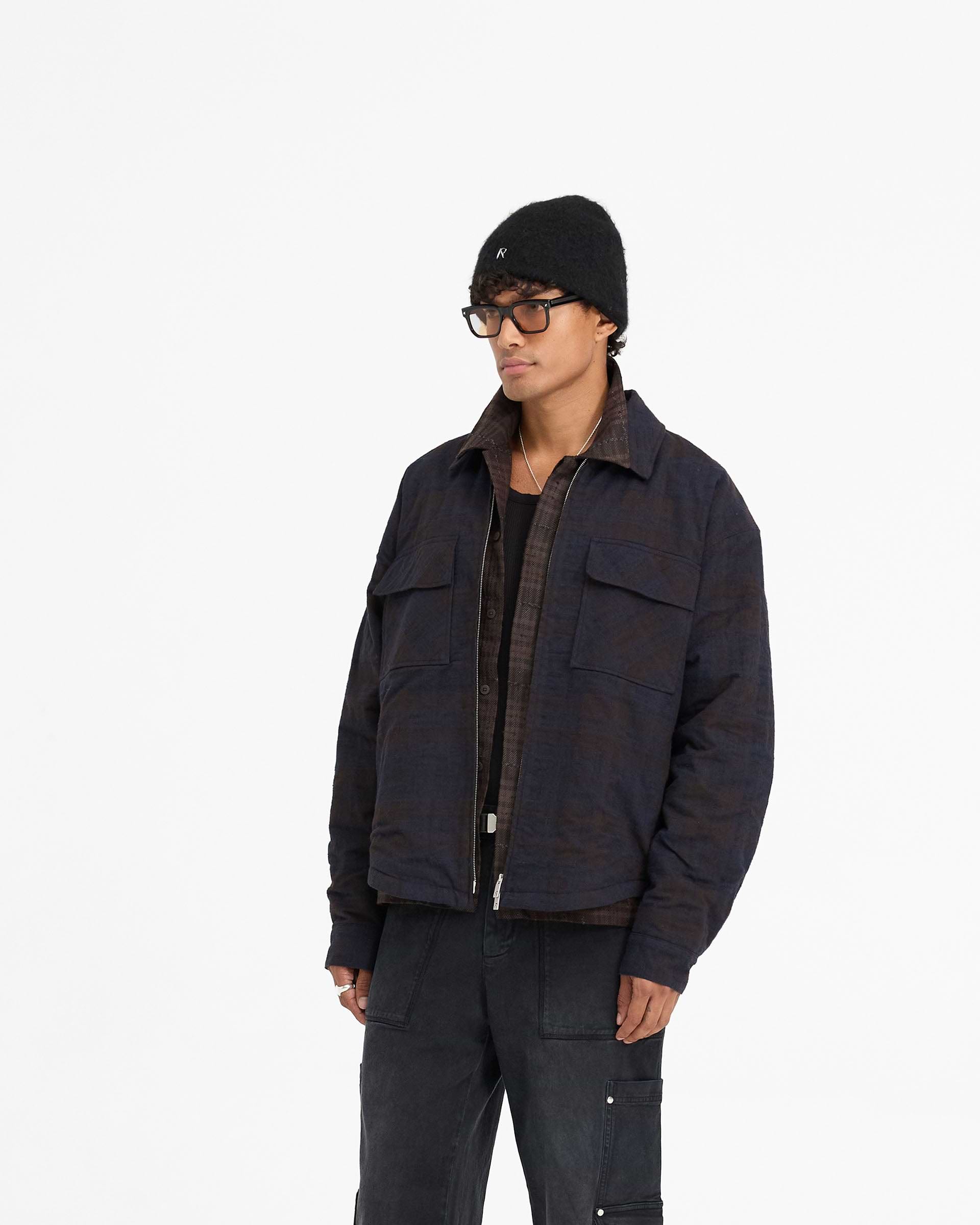 Back product image of a mens navy overshirt on a plain white background | Wadded Zip Overshirt in Midnight Navy | Oversized shirt with flap pockets and double-ended zip | FW24 Shirts | Represent Clo