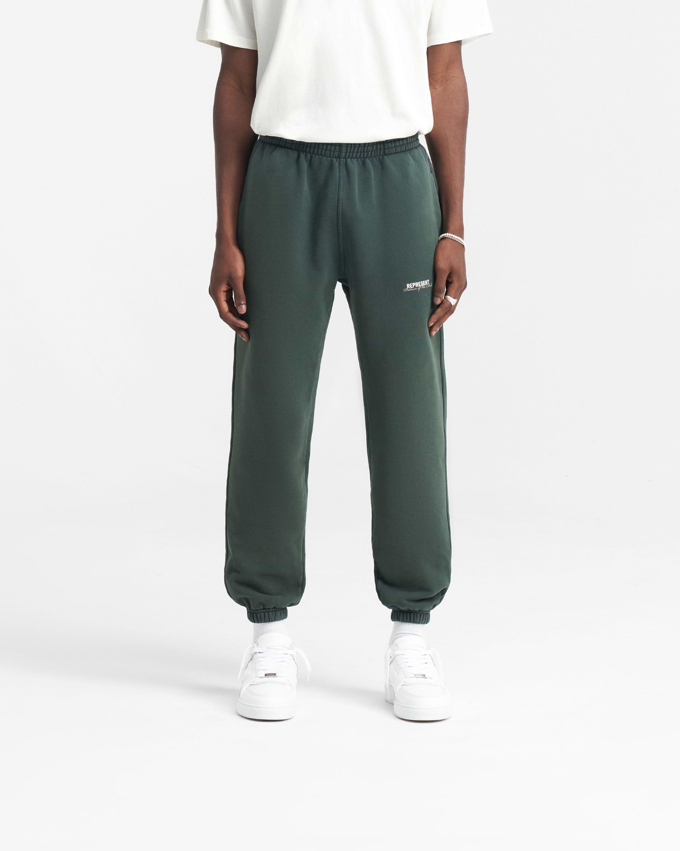 Back product image of mens green sweatpants on a plain white background | Patron Of The Club Sweatpant in Forest Green | Sweatpants with elasticated waistband and cuffs | Patrons Pants | Represent Clo