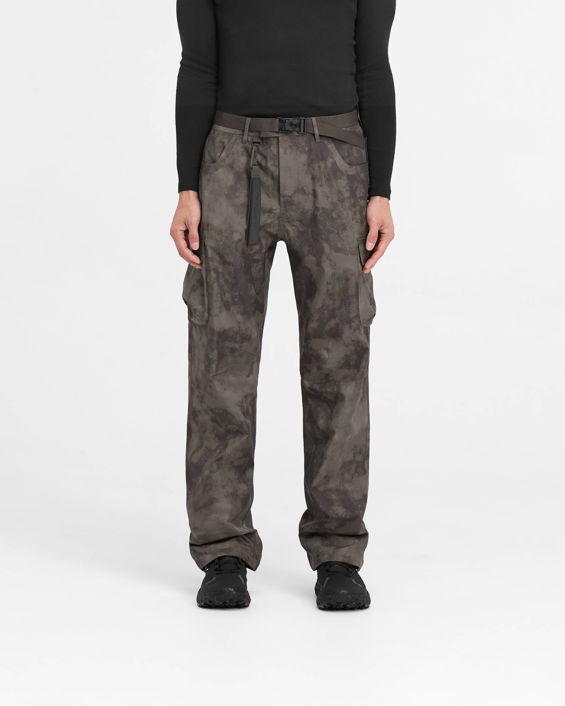 Man wearing straight leg green cargo pants on a plain white background | 247 Technical Cargo Pant in Terrain | Waterproof tech cargos with maglock buckle and bungee cord hem | 247 Pants | Represent Clo