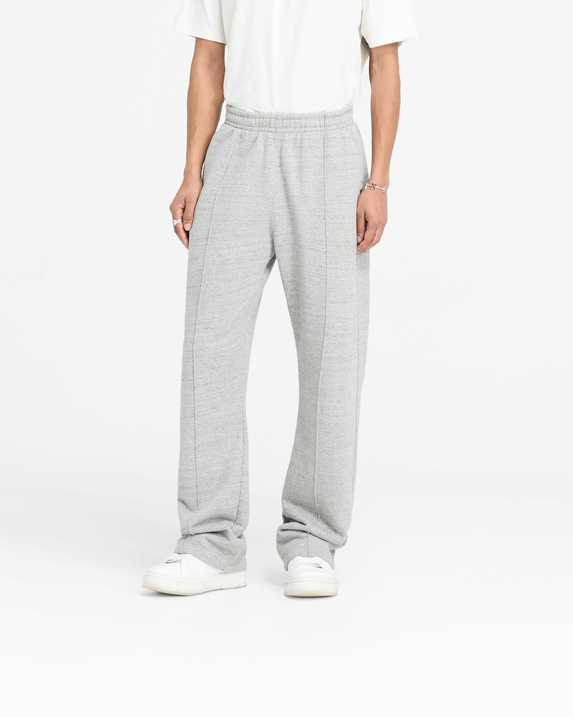 Back product image of mens grey sweatpants on a plain white background | England Applique Sweatpant in Grey Marl | Wide leg sweatpants with pintuck detail and applique embroidery | PRE SS25 Pants | Represent Clo