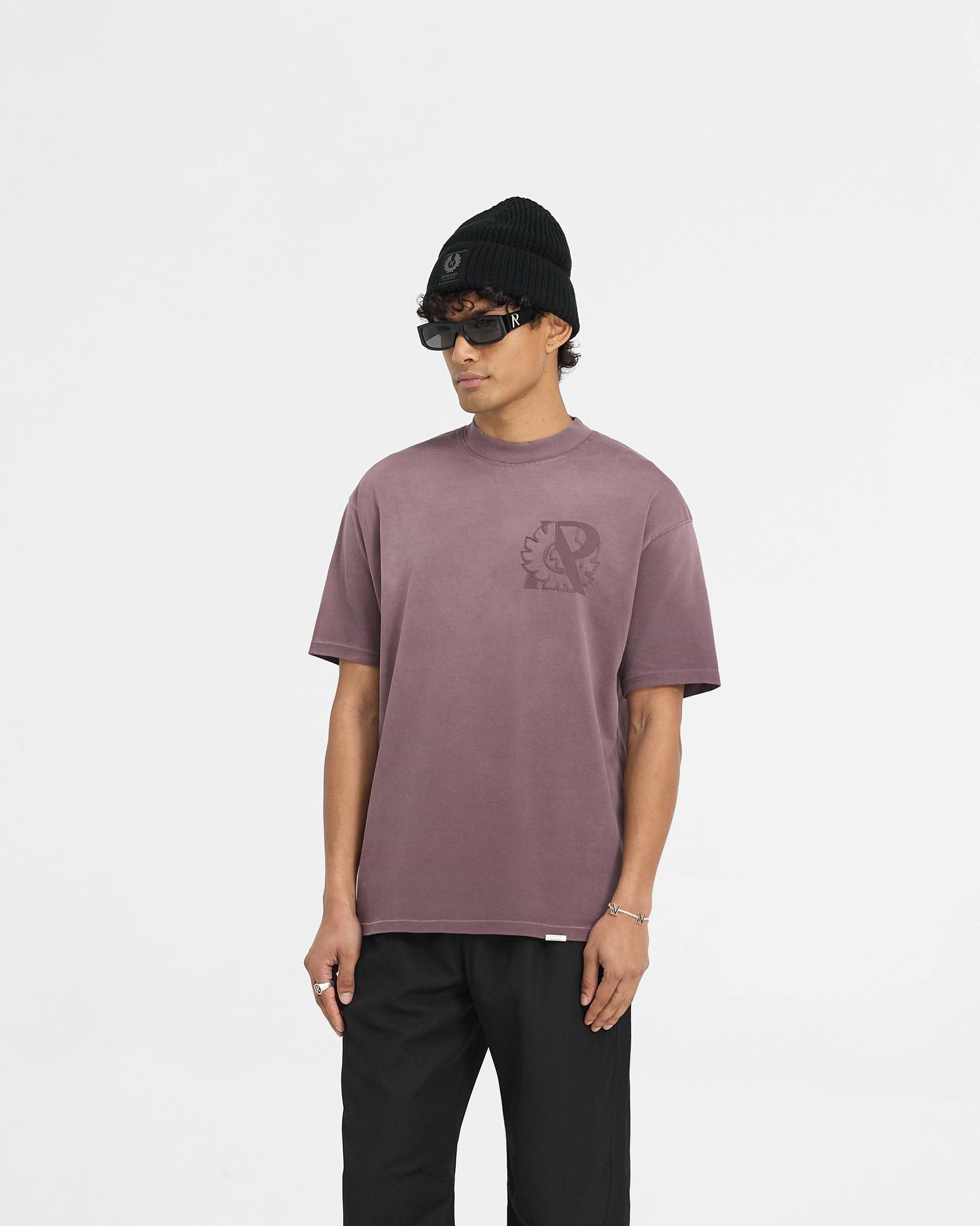 Man wearing a plum t-shirt on a plain white background | Represent X Belstaff Outline Phoenix T-Shirt in Plum | Oversized medium weight t-shirt with stylised logos | Exclusives T-Shirts | Represent Clo